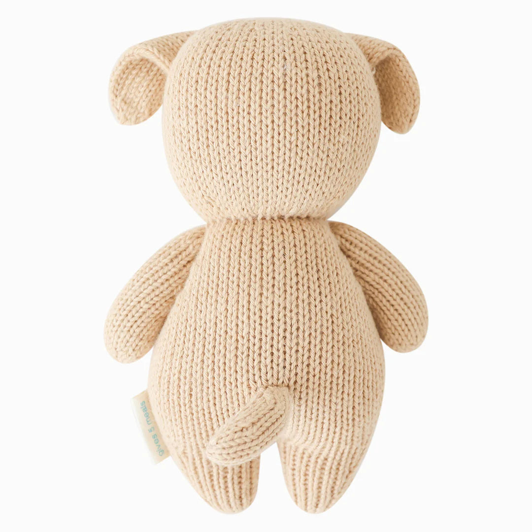 Cute baby puppy plush toy from Cuddle + Kind, soft and cuddly with detailed fur and gentle features.