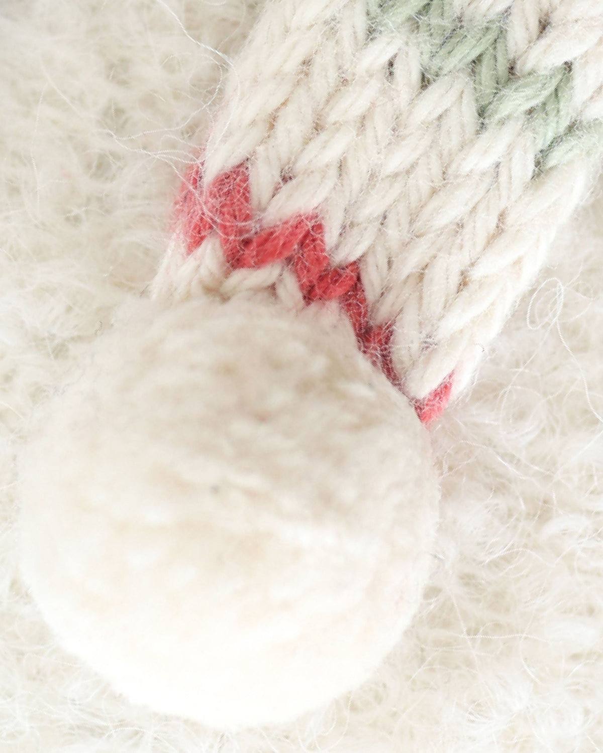 Baby Snowman cuddle toy with peppermint stripe pattern from Cuddle + Kind, featuring soft fabric and adorable winter-themed design.