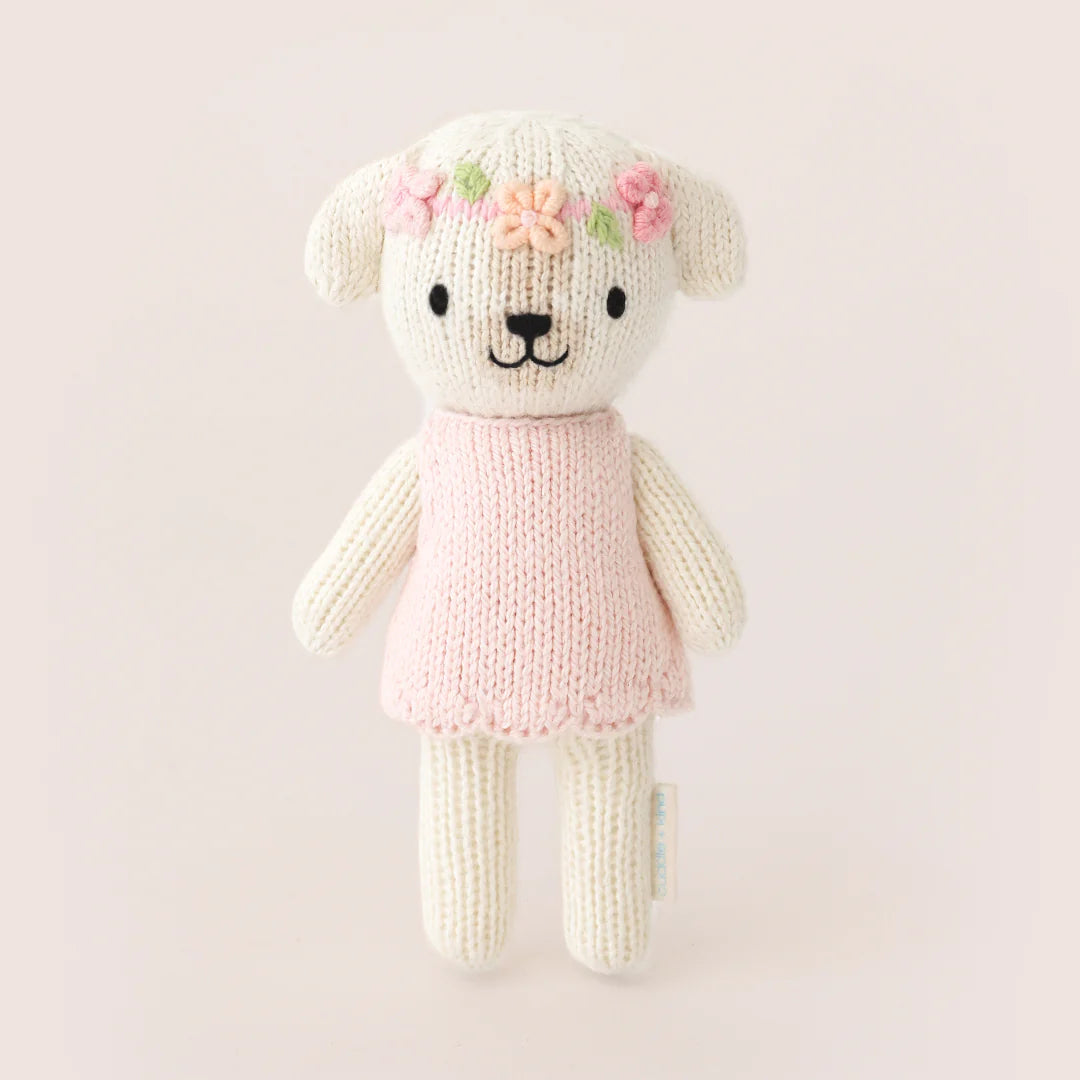 Tiny Charlotte the Dog plush toy by Cuddle + Kind, soft and adorable for children, with detailed fur and expressive eyes.