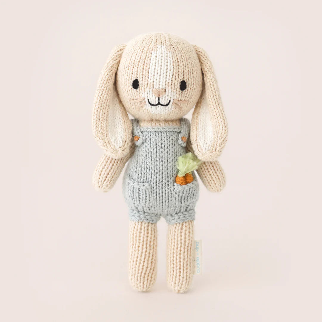 Tiny Henry the Bunny plush toy from Cuddle + Kind featuring soft beige fur, expressive embroidered eyes, and a gentle smile.