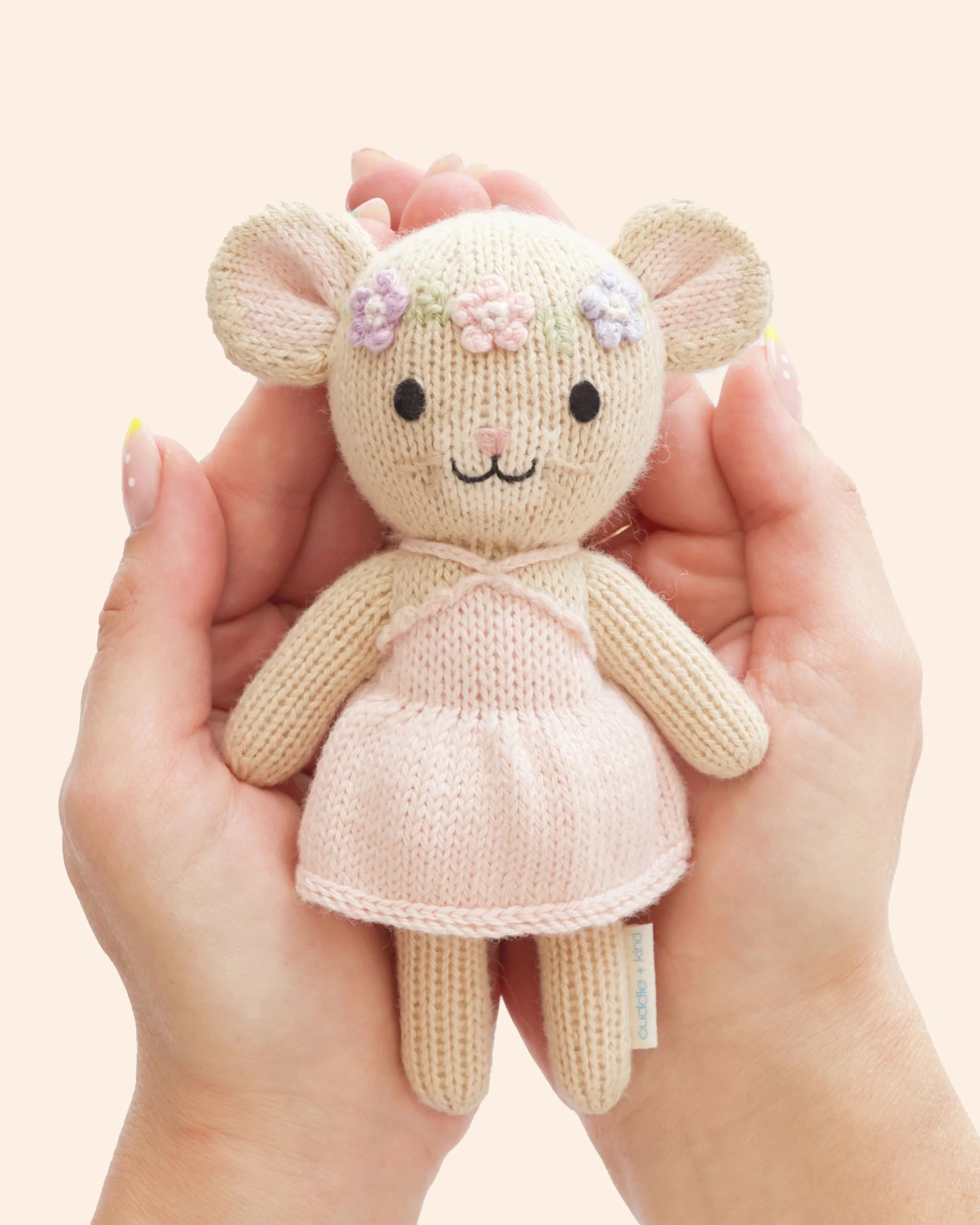 Tiny Emma the Mouse plush toy from Cuddle + Kind with soft gray fur and cute pink ears, perfect for cuddling and children.