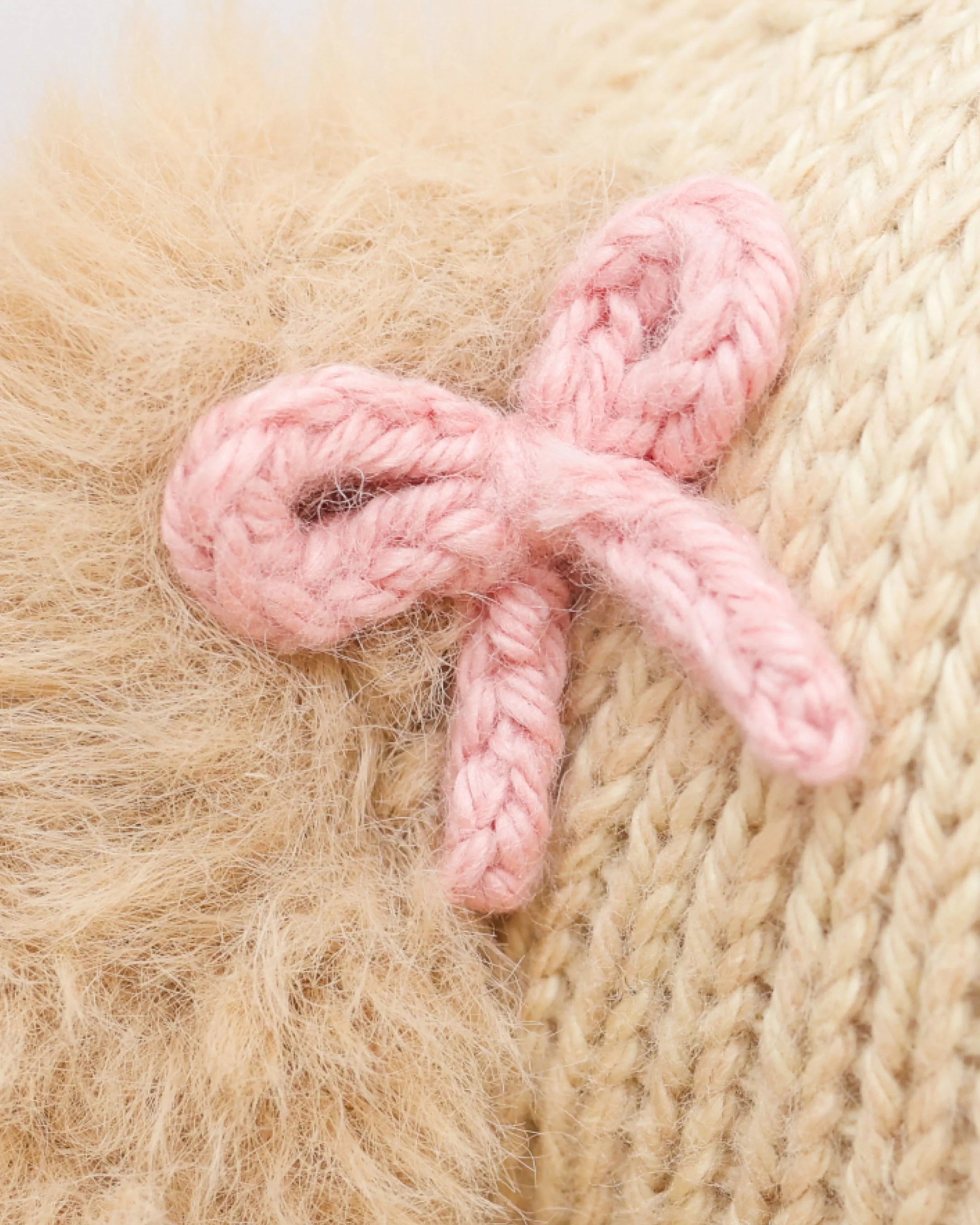 Soft plush golden puppy toy named Nora from Cuddle + Kind, featuring realistic fur and gentle expression, ideal for cuddling.