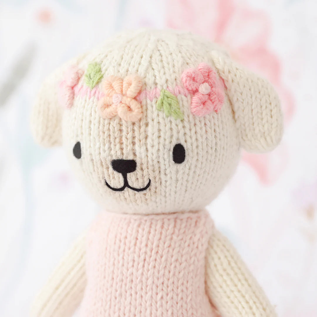 Cute plush Tiny Charlotte the Dog from Cuddle + Kind, soft stuffed animal with detailed fur and gentle expression.