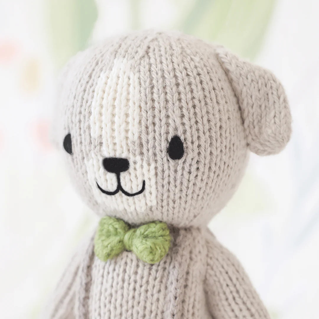 Tiny Noah the Dog from Cuddle + Kind, plush stuffed animal with soft fabric and detailed dog features, ideal for cuddling and play.
