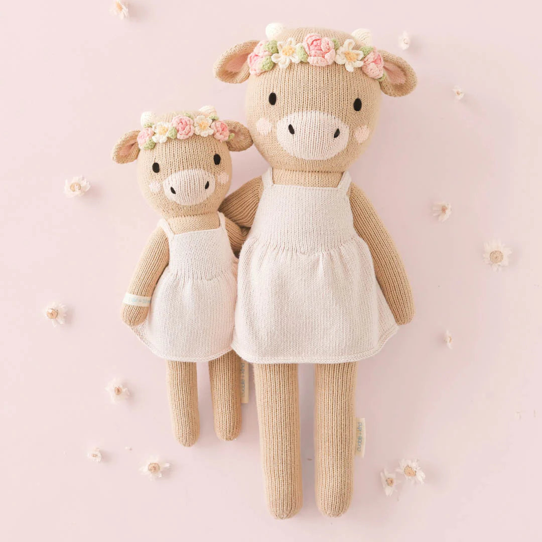 Amelia the Cow plush toy from Cuddle + Kind featuring soft fabric, embroidered facial details, and a gentle, friendly appearance.