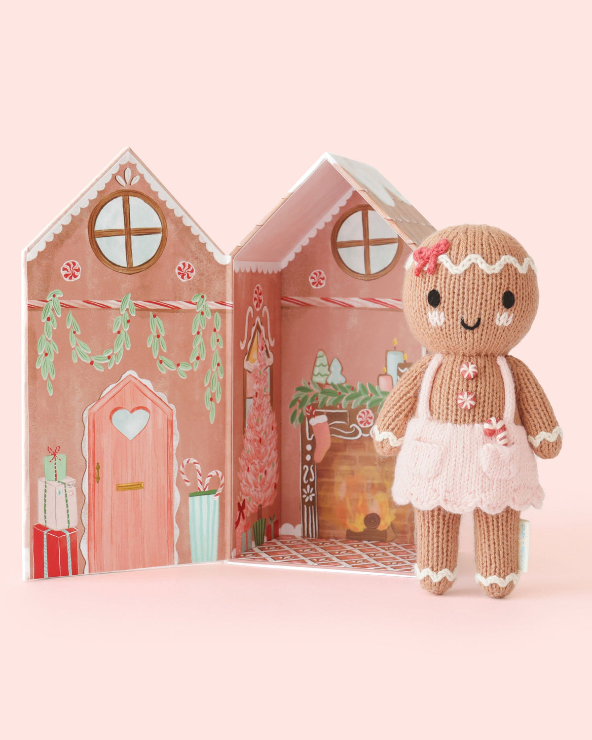 Small gingerbread girl doll from Cuddle + Kind with a sweet swirl pattern, soft fabric, and detailed facial features.