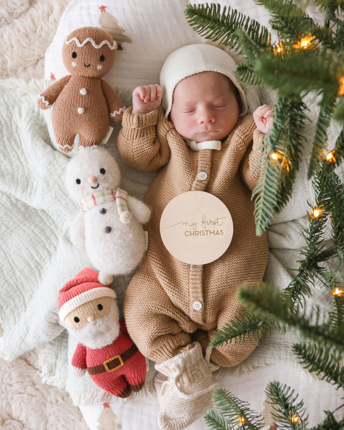 Baby snowman plush toy with peppermint stripe pattern from Cuddle + Kind, featuring soft fabric and adorable winter-themed design.