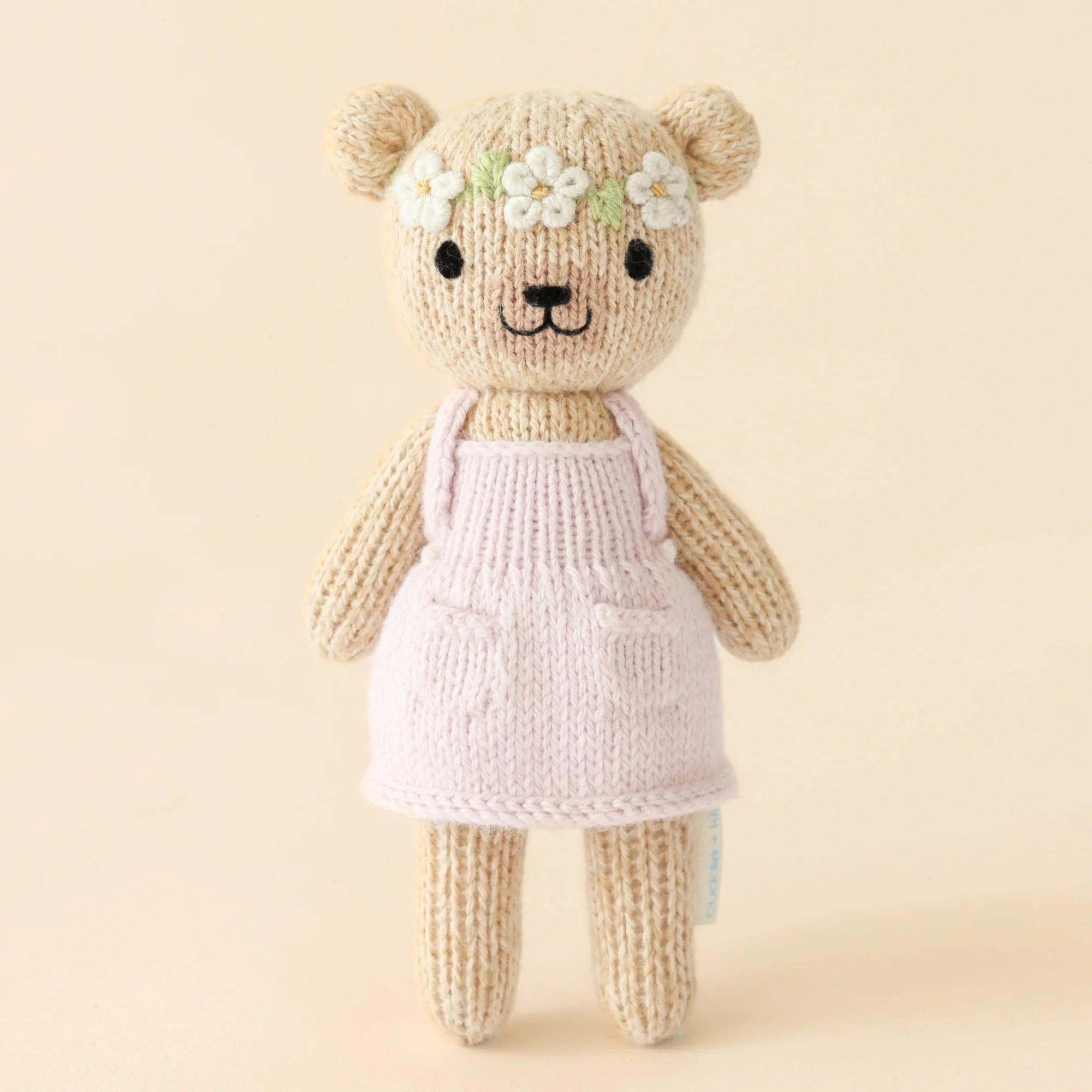 Tiny Olivia the Honey Bear plush from Cuddle + Kind, soft cuddly toy with detailed honey bear design and warm yellow fur.