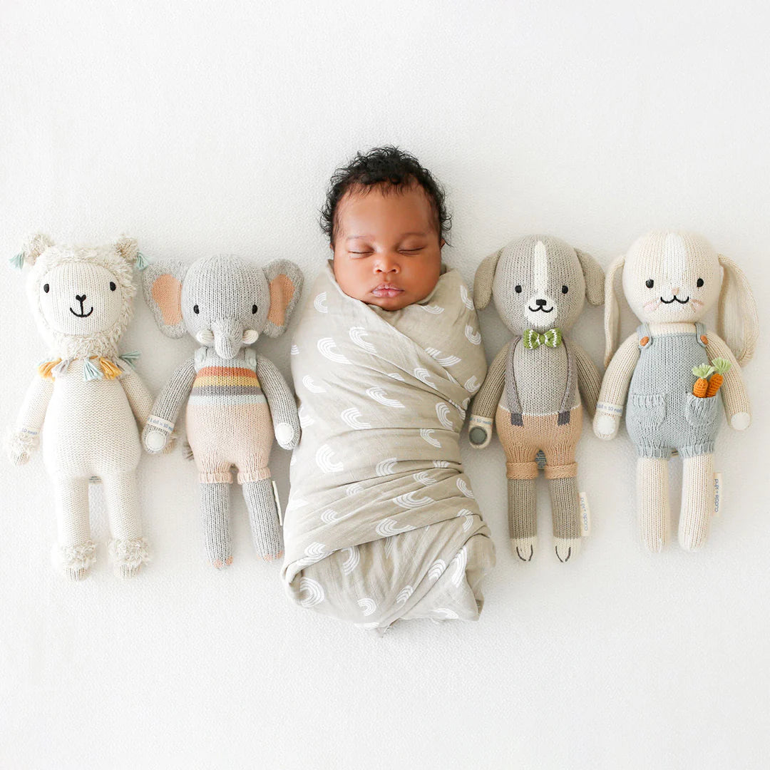 Soft plush Henry the Bunny from Cuddle + Kind, featuring white fur, long floppy ears, and a gentle, friendly expression.