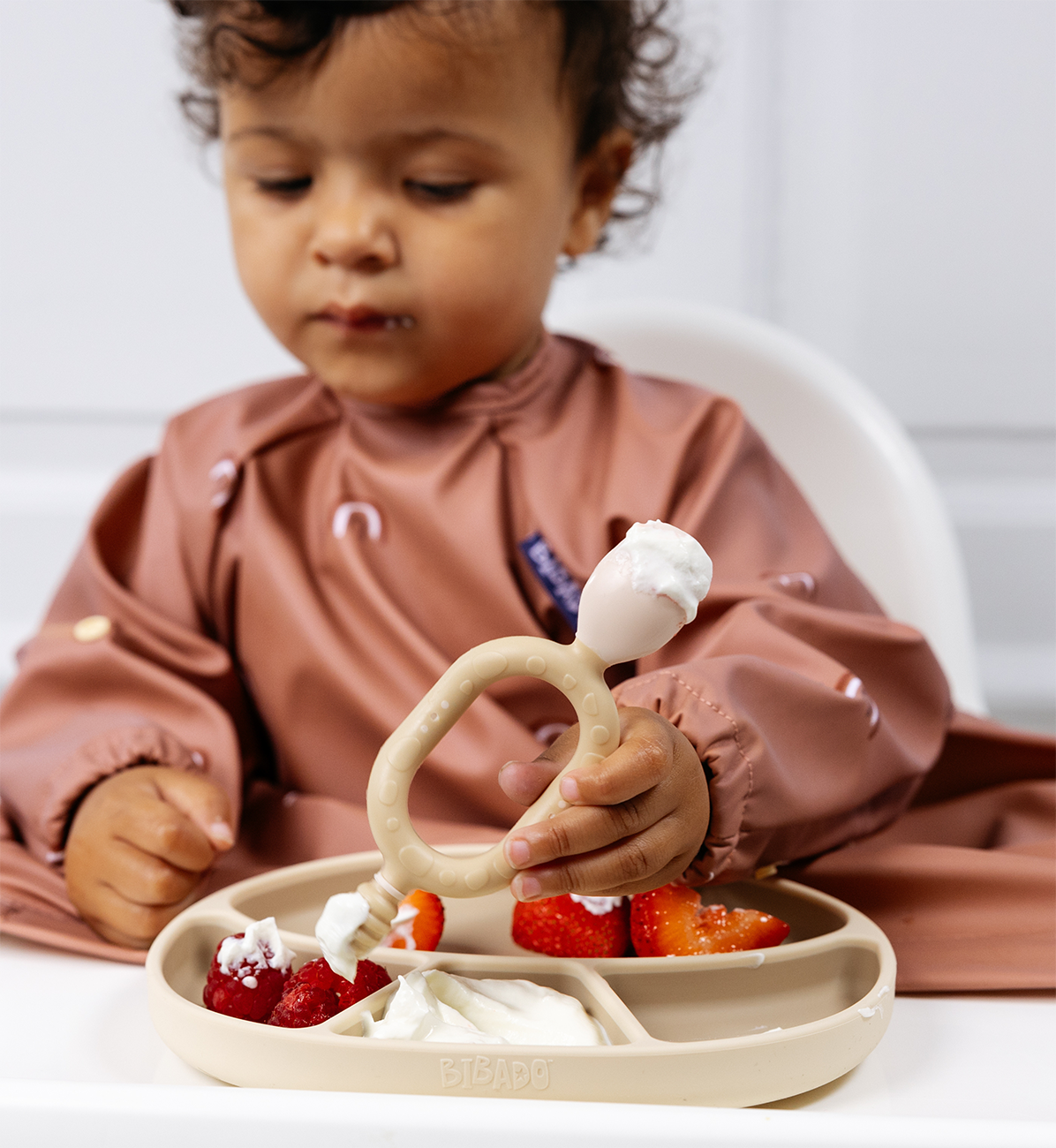 Bibado silicone suction divider plate in fawn color with divided sections for baby’s mealtime.
