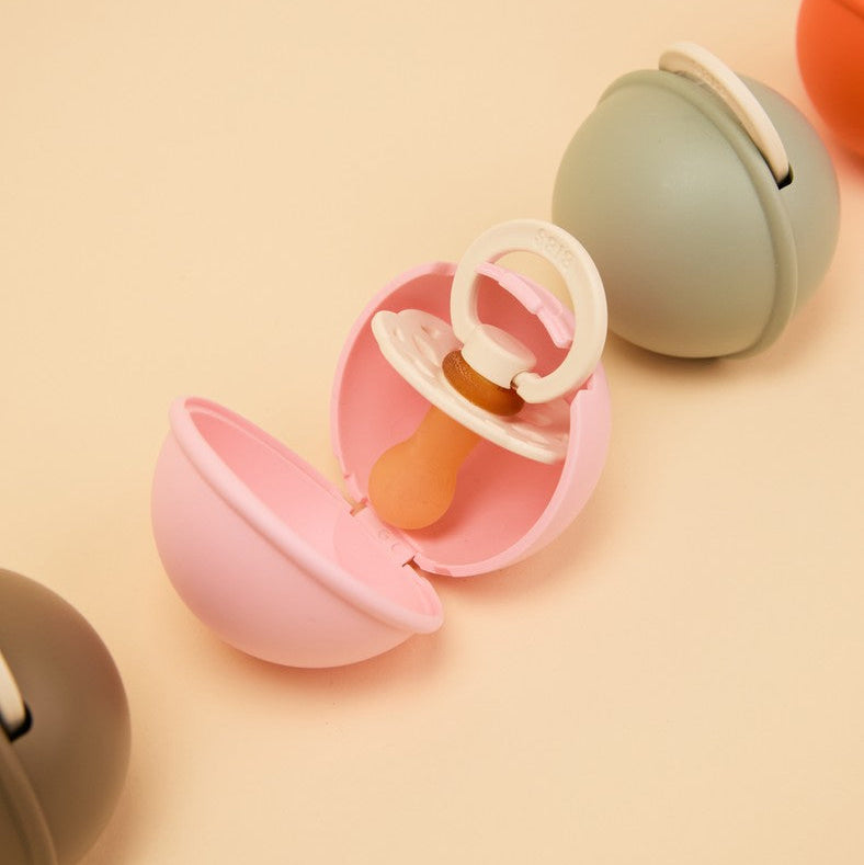 Gnash BIBS Pacifier Case Mini in baby pink, a compact accessory with a soft silicone exterior for storing pacifiers.