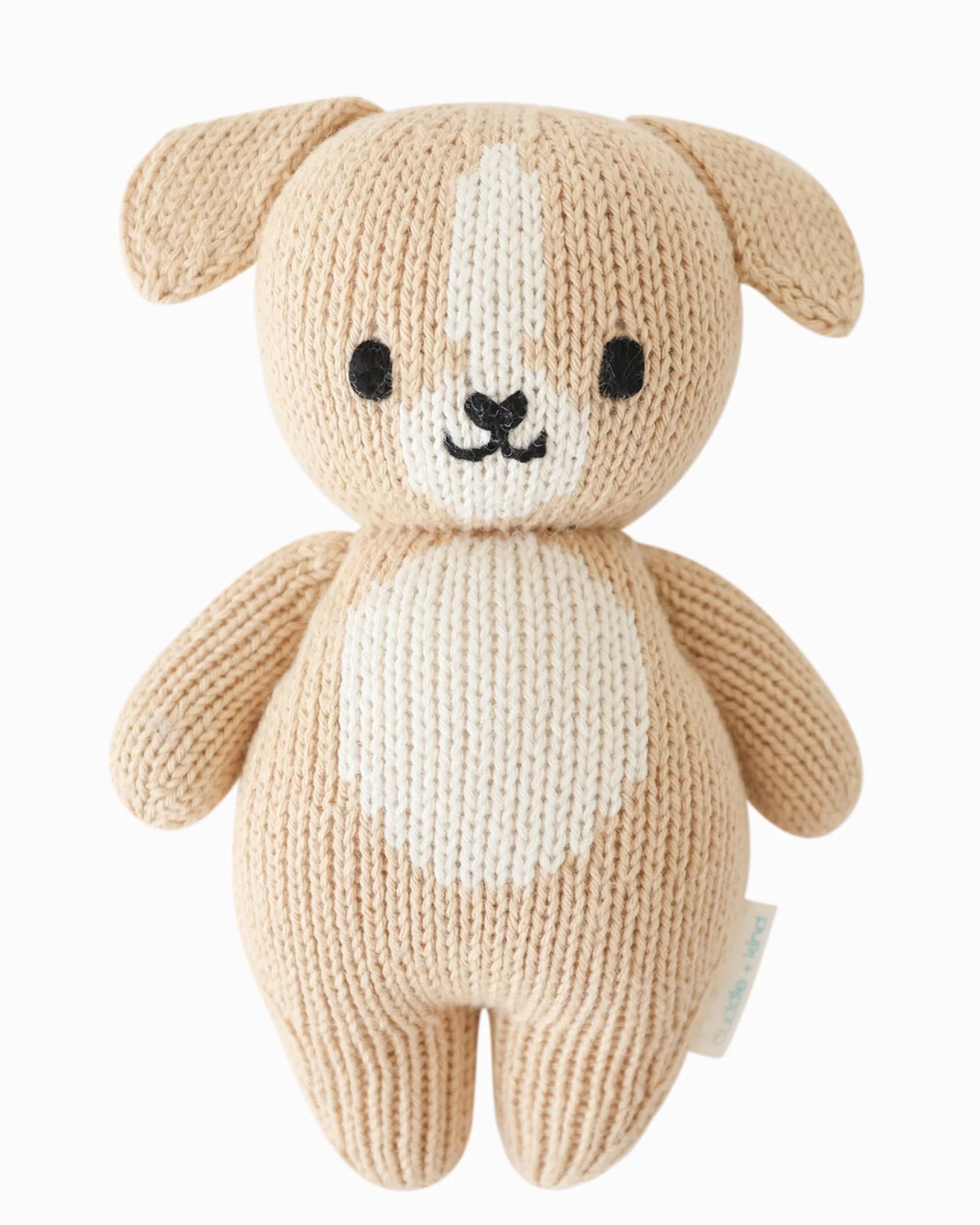 Soft plush baby puppy toy from Cuddle + Kind, featuring a cute, cuddly puppy with detailed fur and gentle expression.