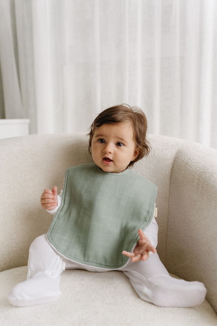Bubbadue oversized pale blue feeding bib with waterproof material and adjustable neck strap for babies.