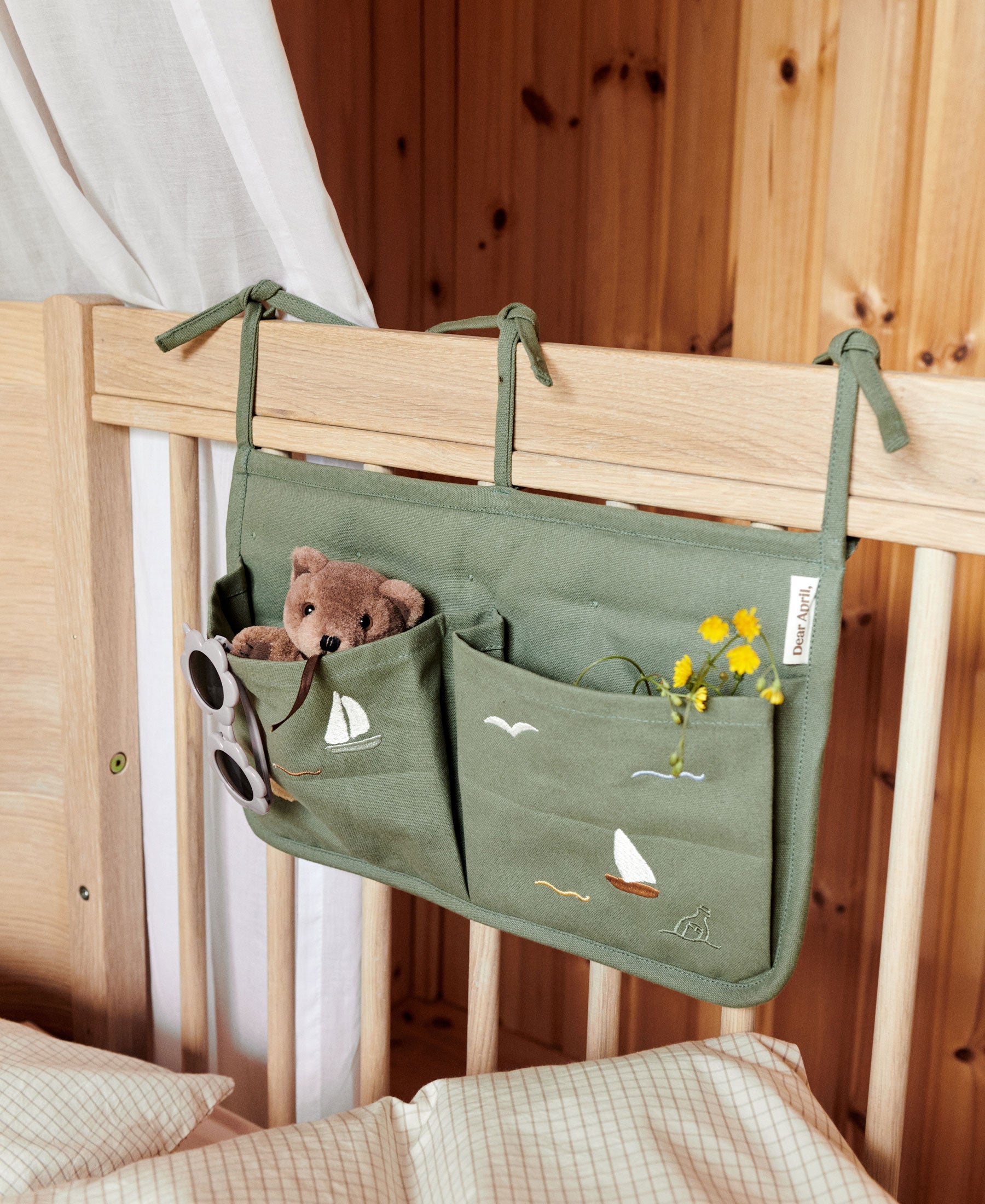 Dear April Sailboats Posy Bed Pocket hanging organizer with multiple pockets for bedside storage on a bed or wall.
