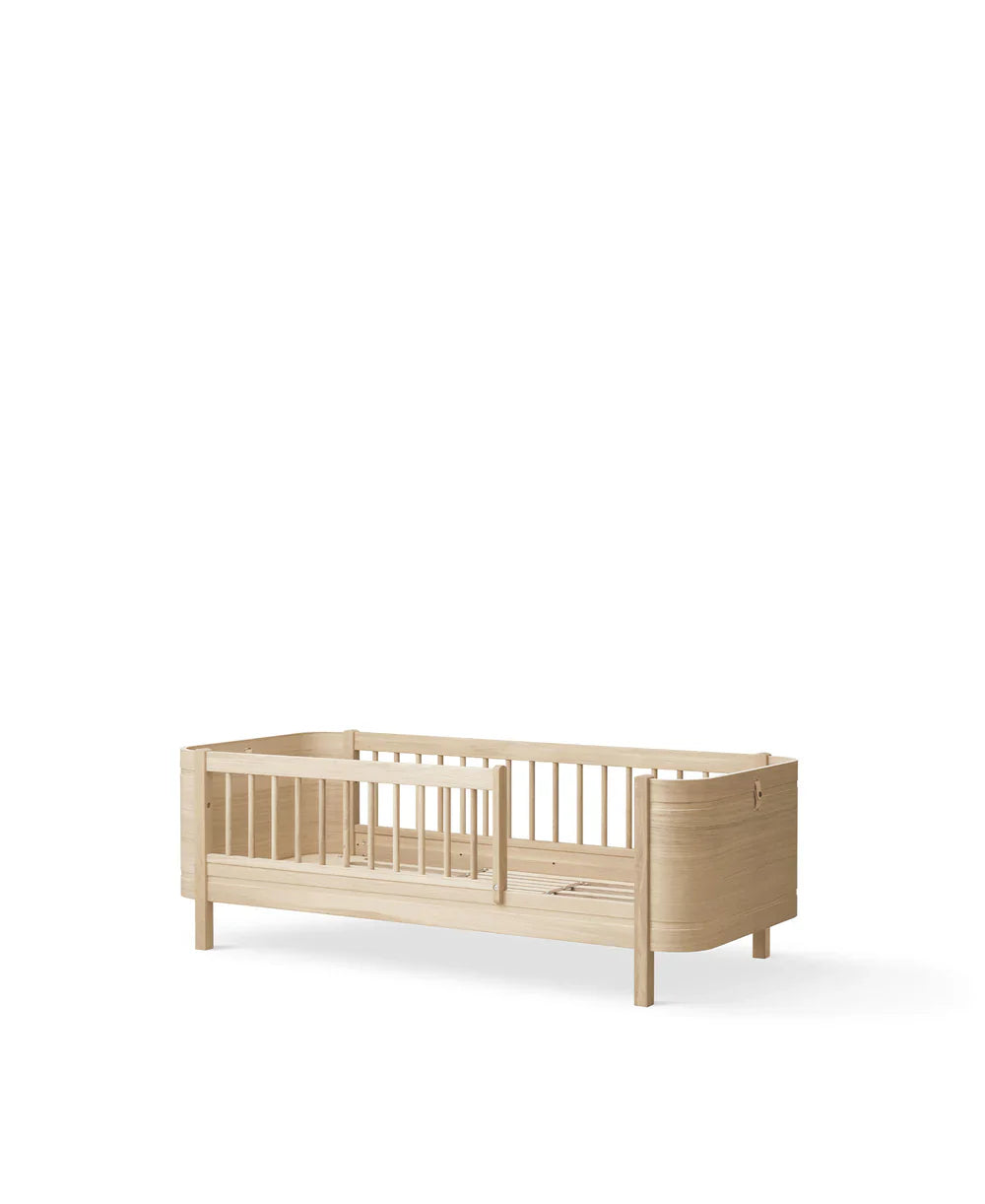 Wood Mini+ cot bed in oak with junior kit by Oliver Furniture, featuring a compact, stylish children's furniture design.