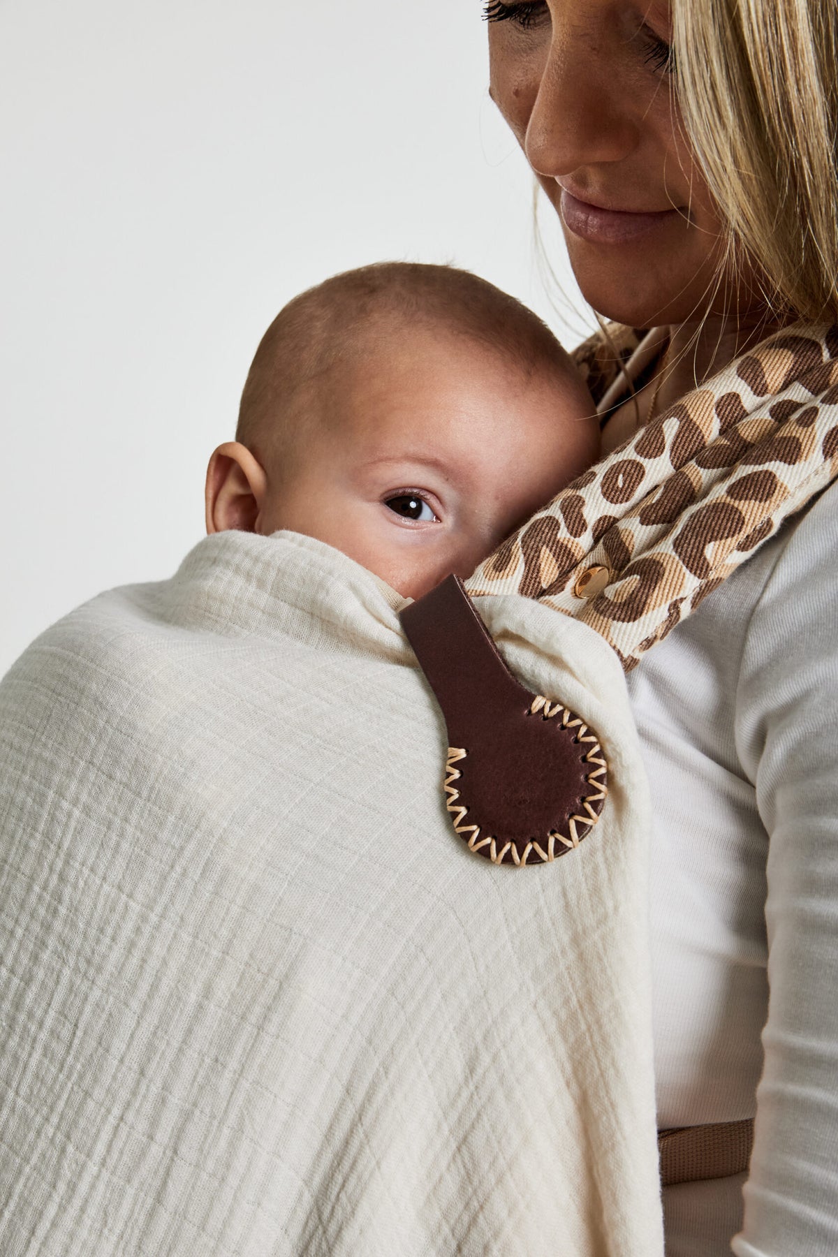 Constantia Mocha Stella Clip with cream stitching on a pram