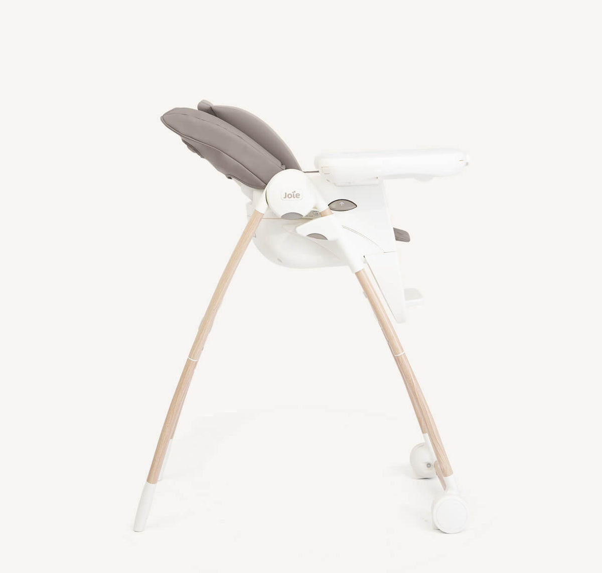 Joie Multiply 6-in-1 high chair in walnut wood with a sleek design, showing the adjustable tray and sturdy frame.