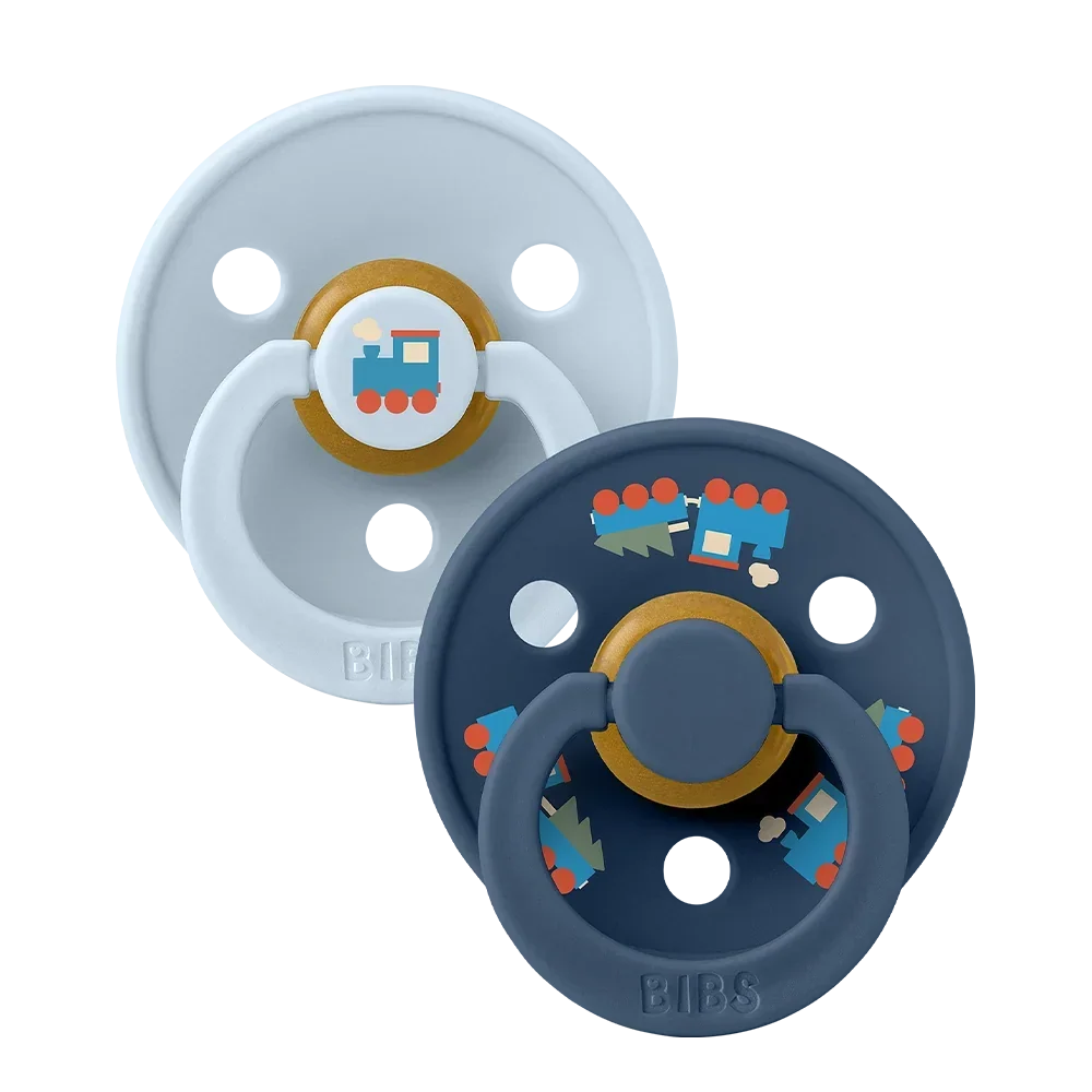 Gnash BIBS Colour Pacifiers 2 Pack with holiday train design in baby blue and steel blue, soft accessories for babies.