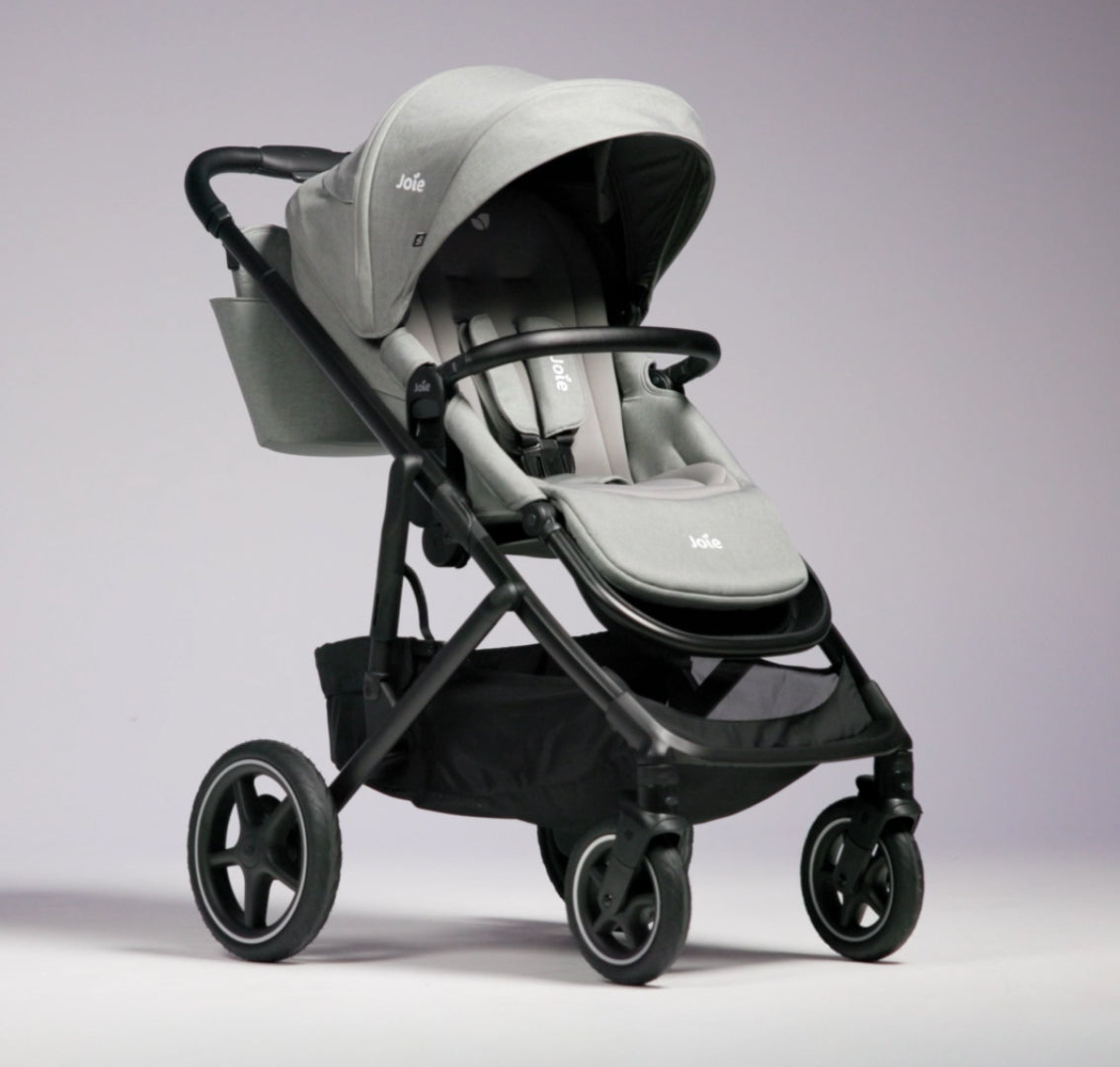 Joie Elara all-suspension stroller in Raven with adjustable handlebar, compact design, and padded seat for comfortable city outings.
