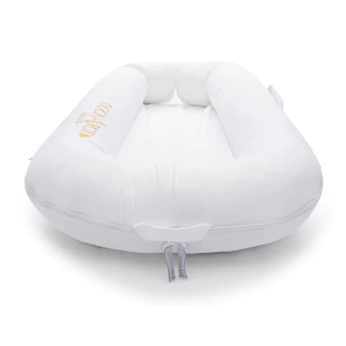 Pristine white Dock-A-Tot Deluxe+ Baby Dock for 0-8 months, soft padded side with adjustable straps, perfect for safe infant lounging