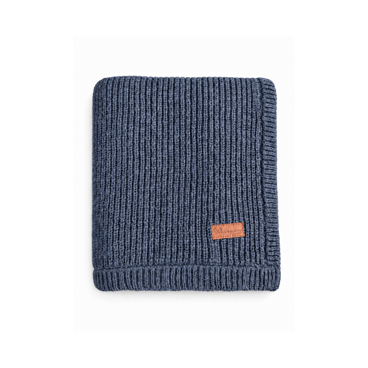 Navy Bubbadue Whisper weighted knitted blanket draped over a cozy armchair, showcasing its soft, textured fabric and calming design.