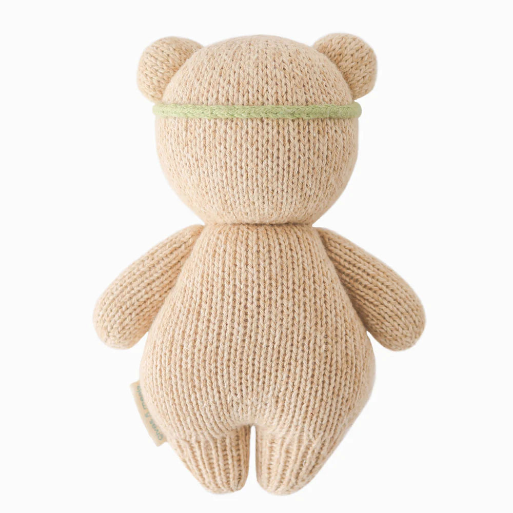 Back view of Baby Honey Bear plush toy in ivory floral pattern by Cuddle + Kind, soft and cuddly for babies.