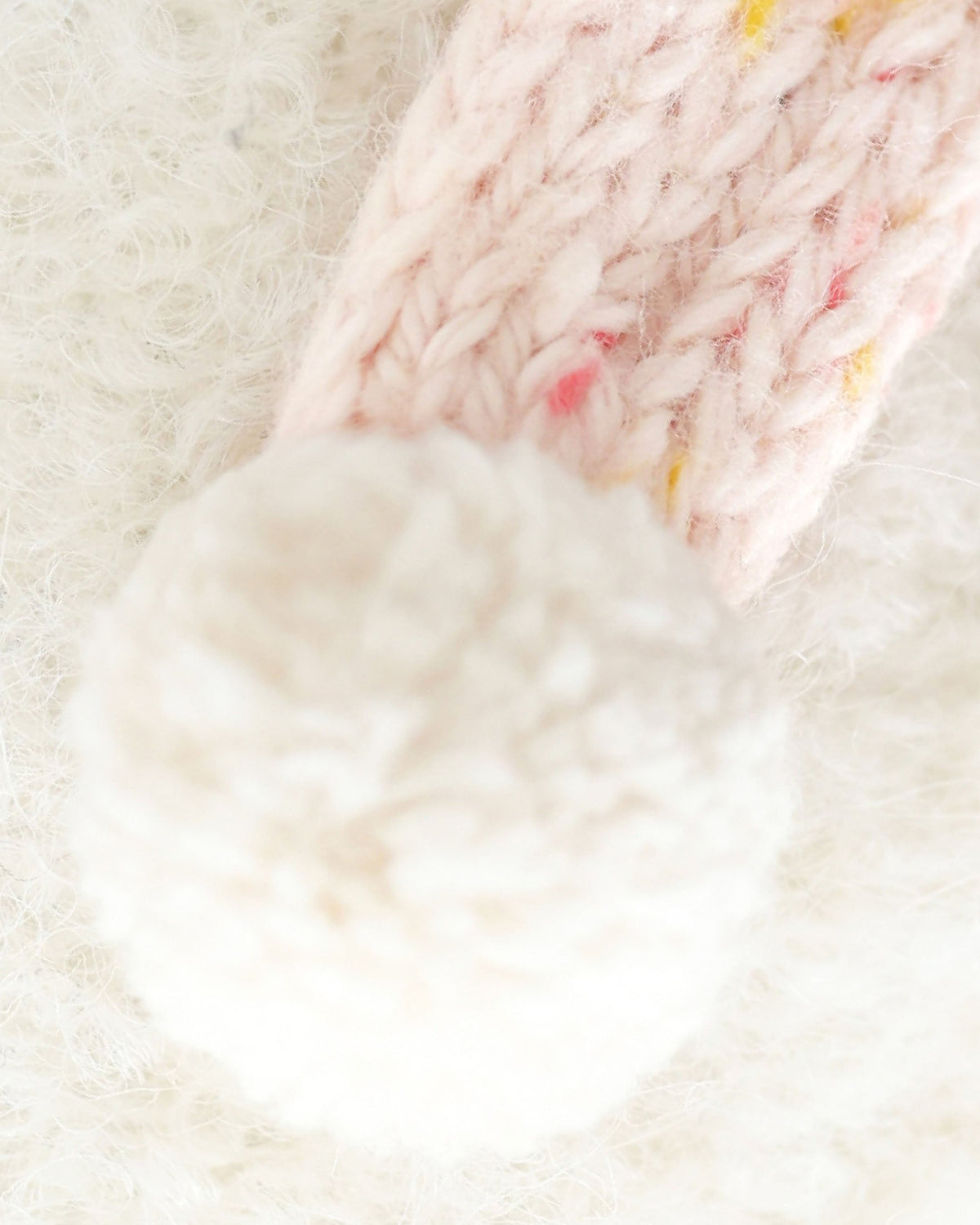 Baby Snowman plush toy by Cuddle + Kind featuring candy fleck pattern, soft fabric, and adorable winter-themed design.