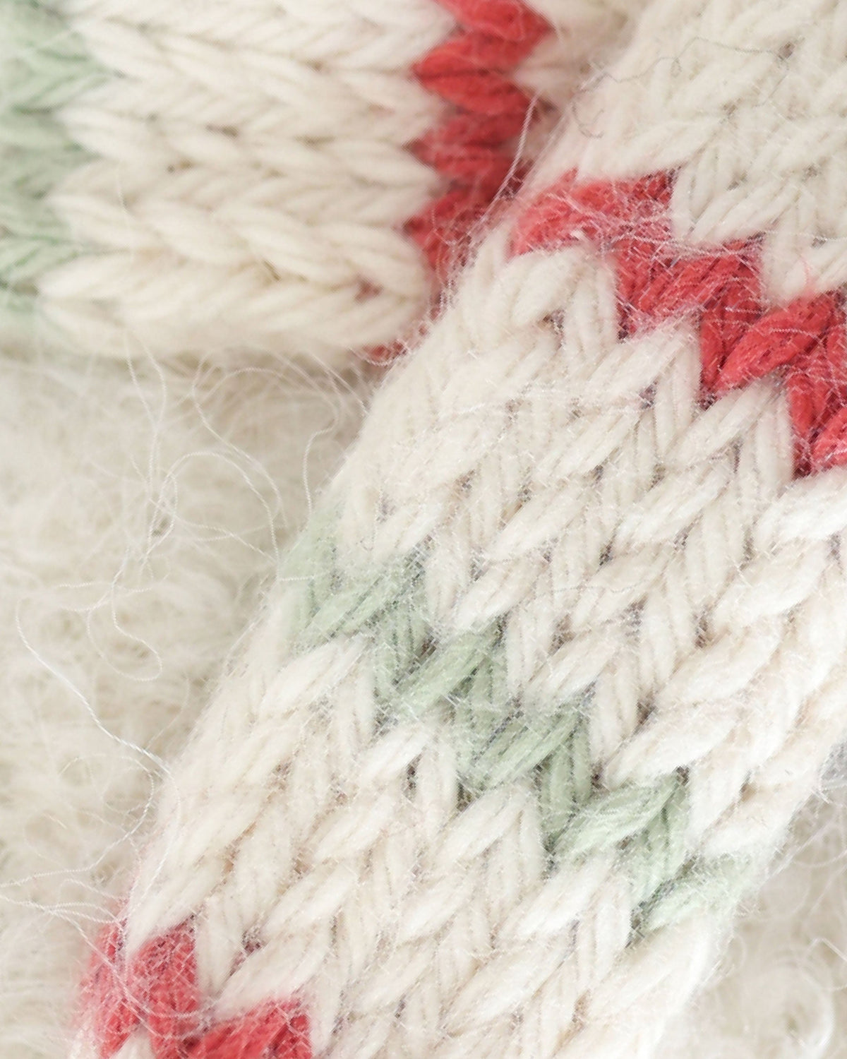 Baby Snowman plush toy with peppermint stripe pattern from Cuddle + Kind, showing soft fabric and cute winter design.