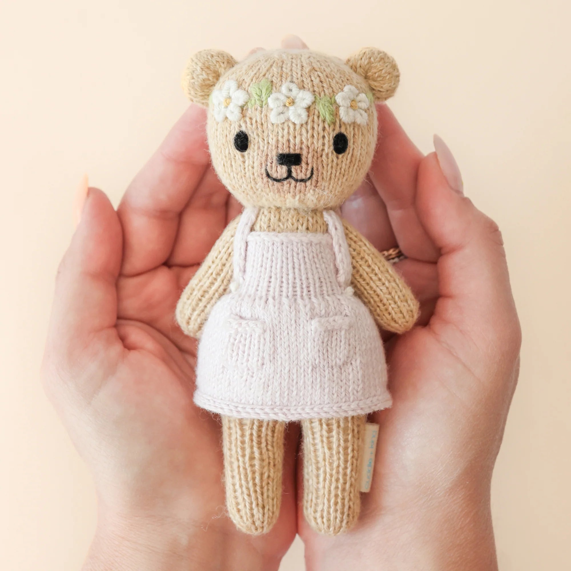 Tiny Olivia the Honey Bear plush toy by Cuddle + Kind with soft, cuddly fabric and adorable honey bear design.
