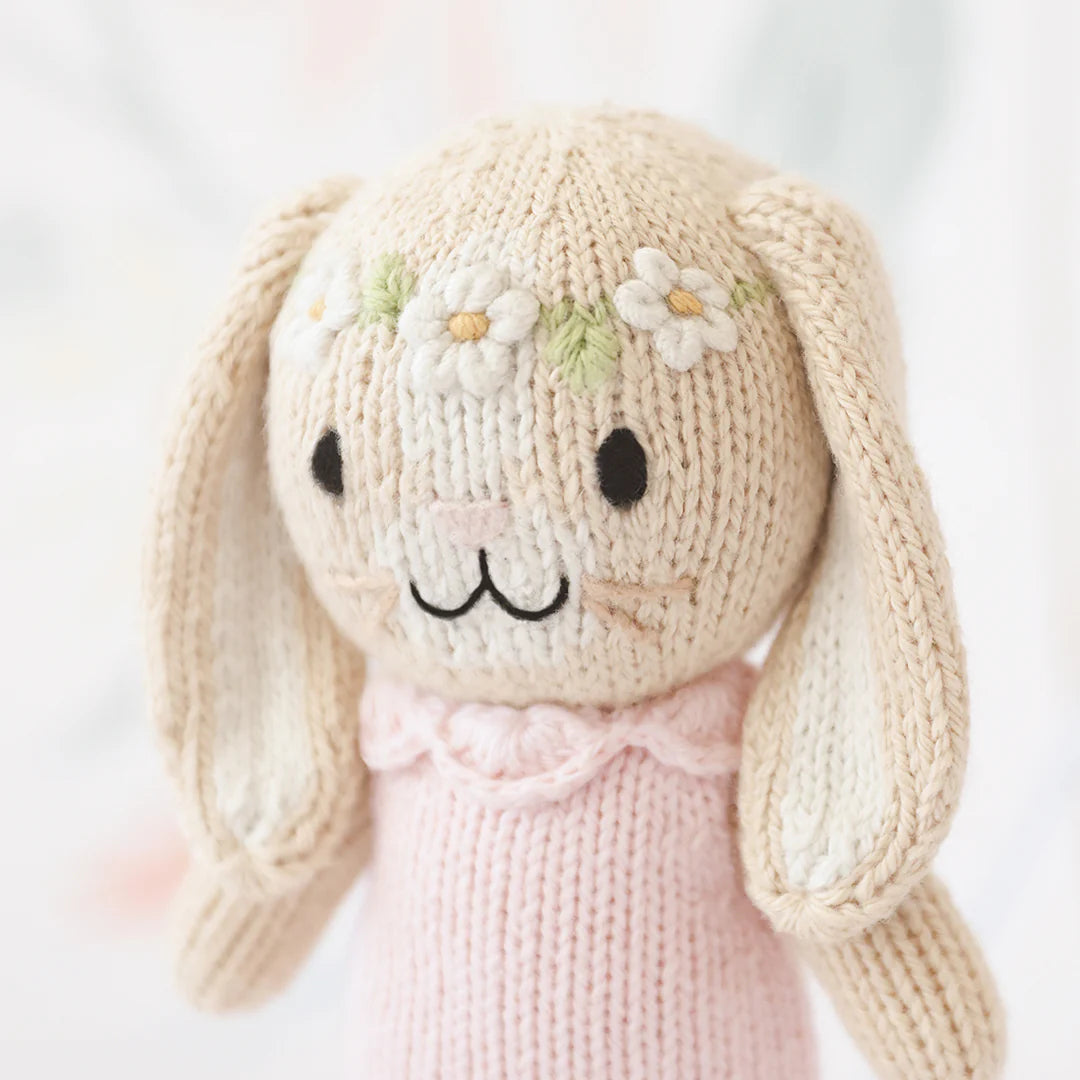 Tiny Hannah the Bunny plush toy in blush pink from Cuddle + Kind, featuring soft fabric and adorable bunny details.