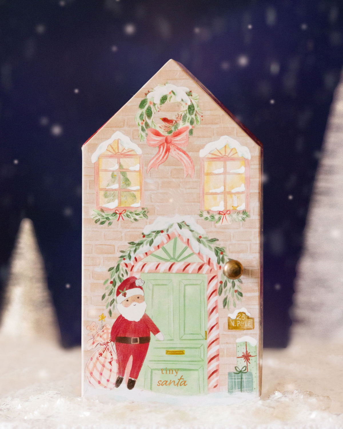 Tiny Santa plush toy from Cuddle + Kind featuring a soft, cuddly Santa Claus with a red hat and festive outfit.