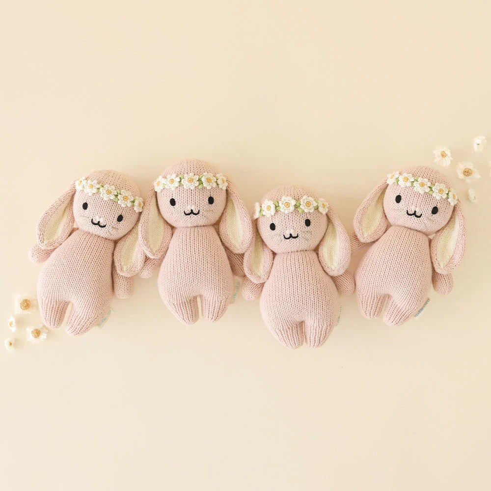 Baby Bunny plush toy by Cuddle + Kind in rose with ivory floral pattern, soft and cuddly for infants and toddlers.