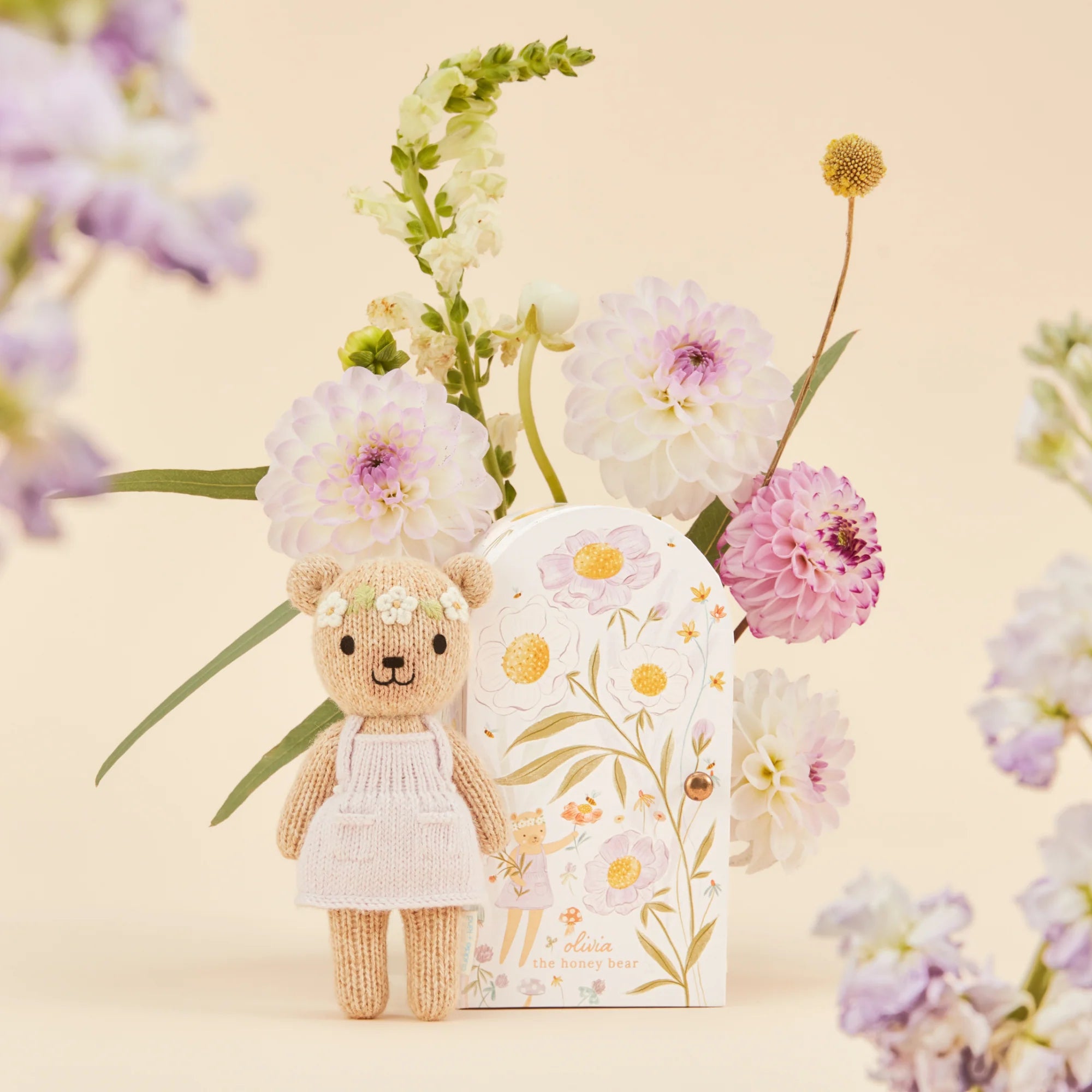 Small plush Tiny Olivia honey bear from Cuddle + Kind with soft fabric and adorable bear features, perfect for cuddling.