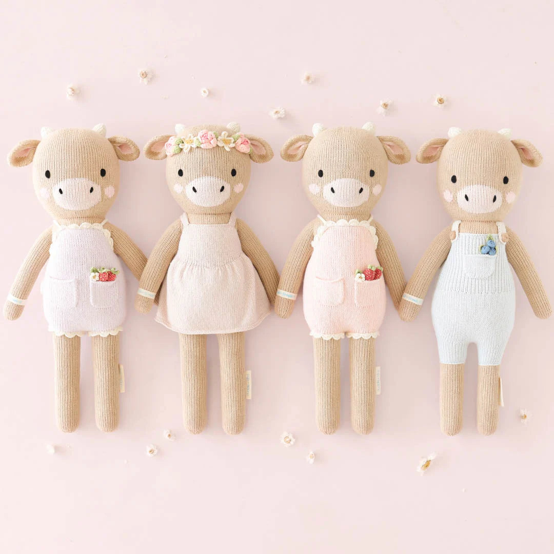 Amelia the Cow plush toy by Cuddle + Kind featuring soft fabric and embroidered facial details, designed for children.