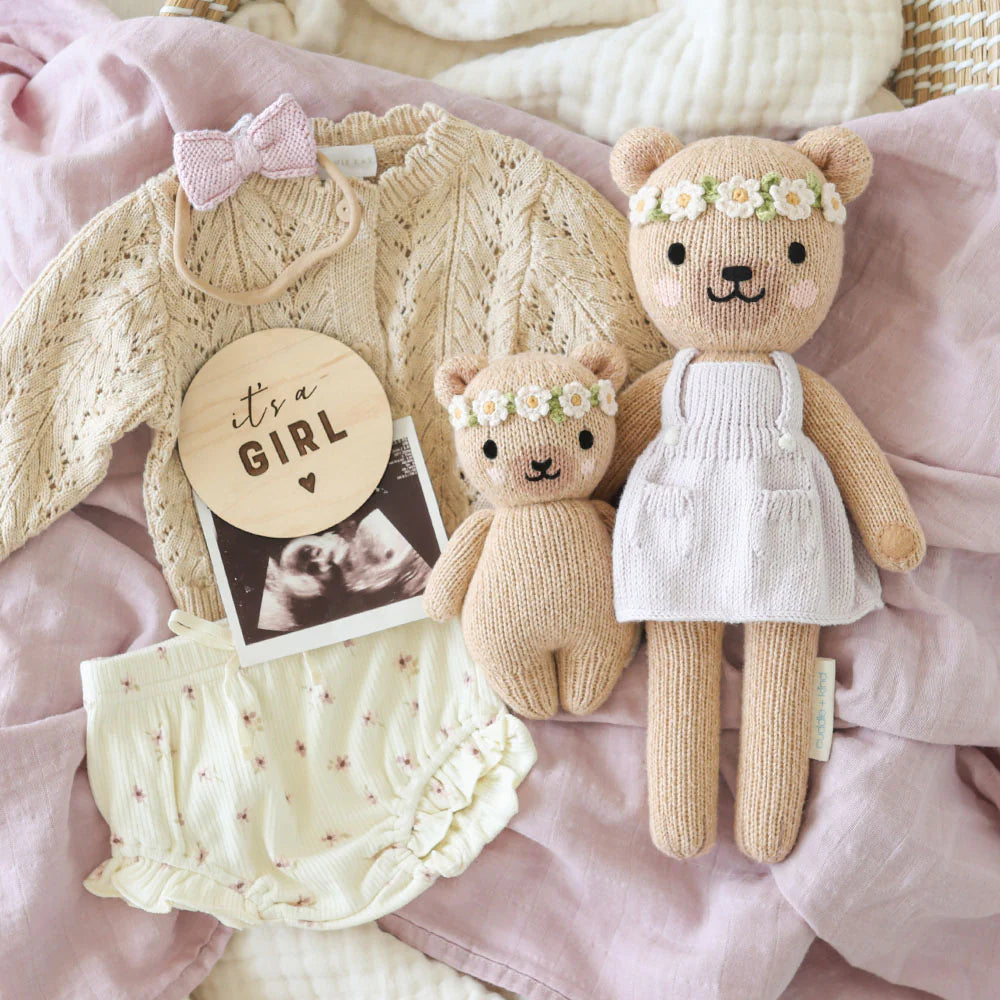Cute Baby Honey Bear plush toy by Cuddle + Kind in ivory floral fabric, designed for cuddling and comfort.