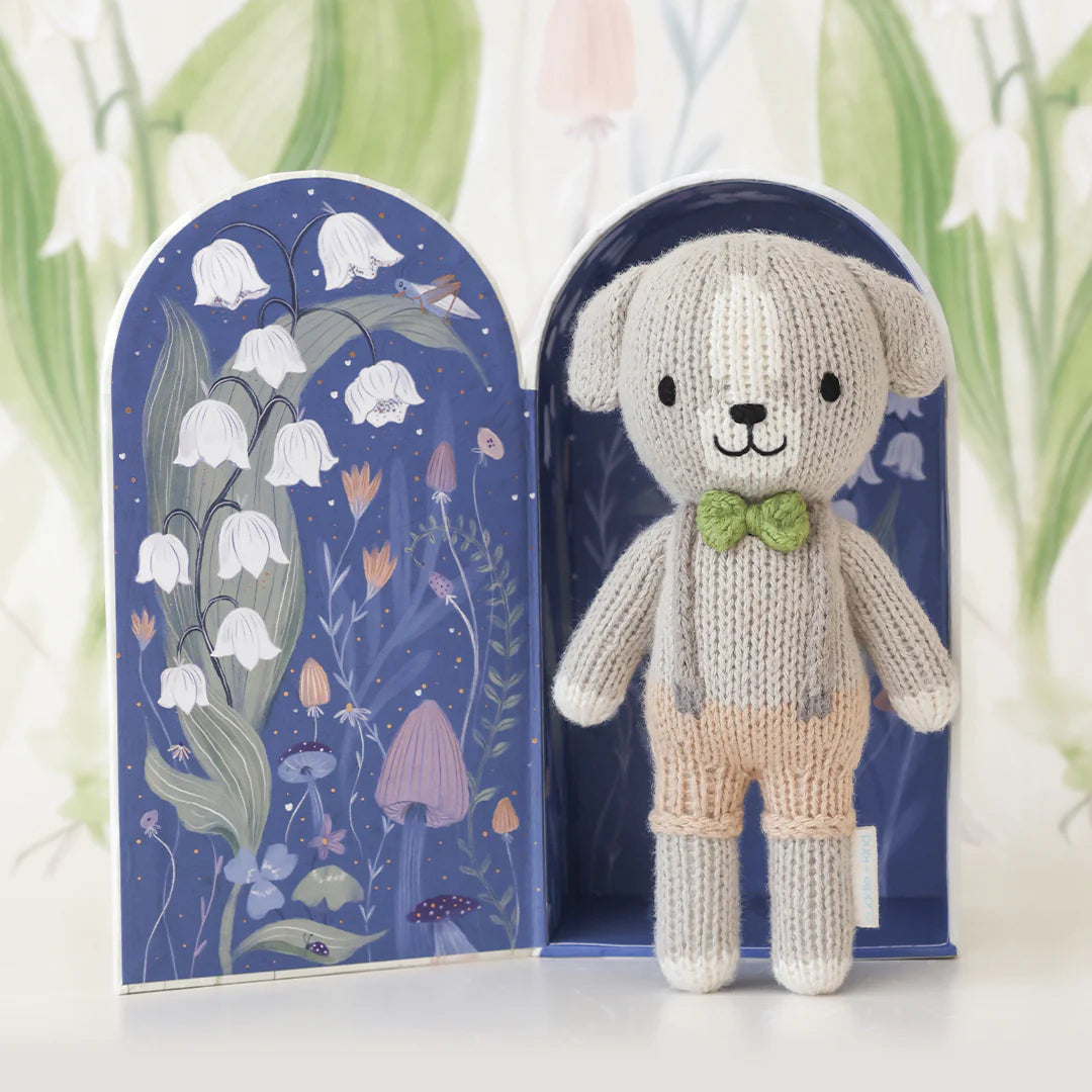 Tiny Noah the Dog plush from Cuddle + Kind, soft and cuddly stuffed dog toy with detailed fur and expressive eyes.