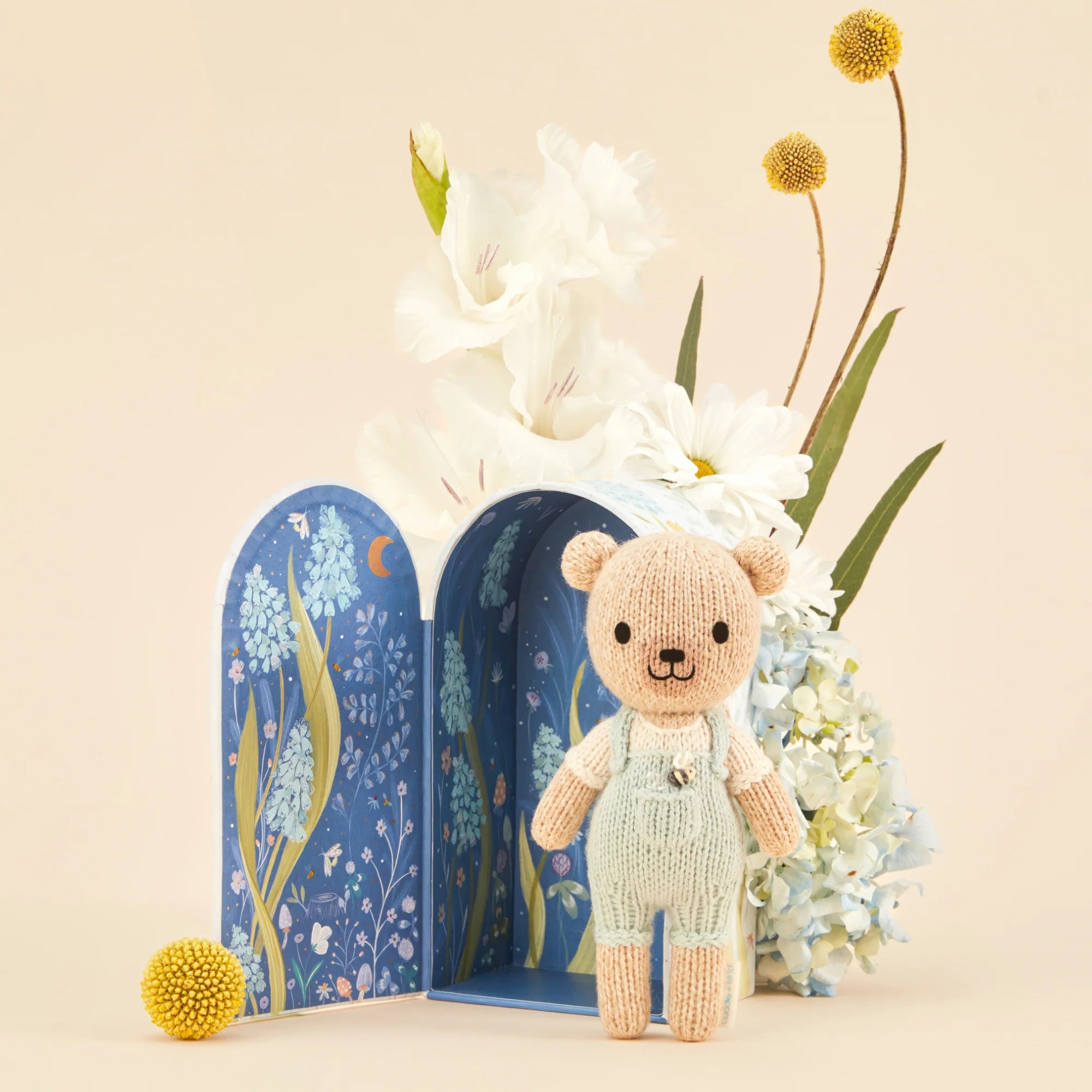 Tiny Charlie the Honey Bear plush toy by Cuddle + Kind, featuring soft fabric and adorable bear design for cuddling.