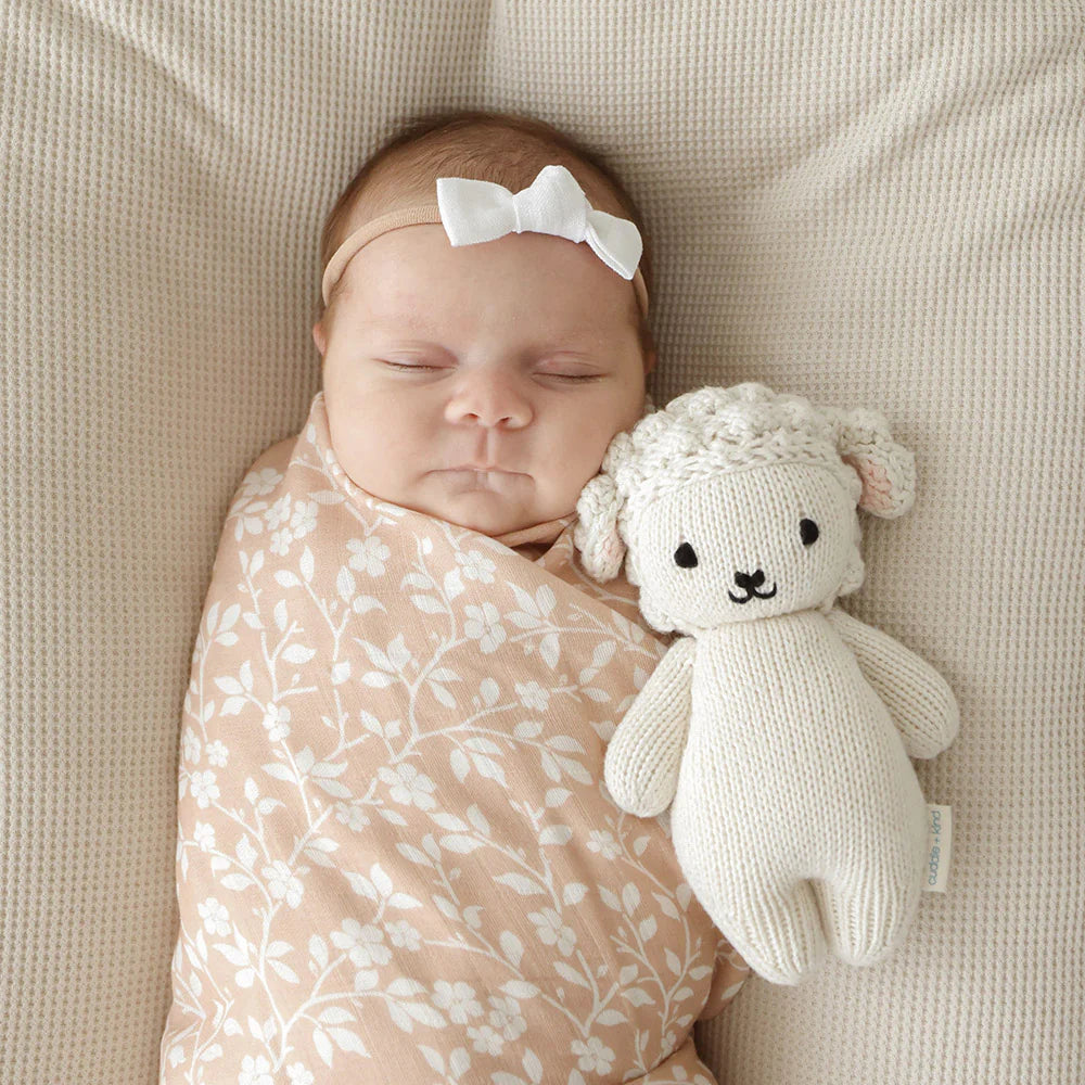 Soft Baby Lamb plush toy from Cuddle + Kind with detailed woolly fur and gentle face, perfect for cuddling and comforting.