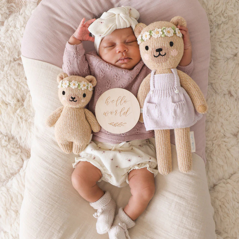 Baby Honey Bear plush toy from Cuddle + Kind featuring an ivory floral design, soft and cuddly for infants.