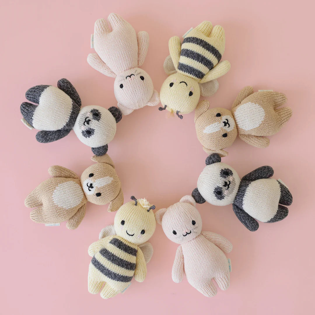 Soft plush baby puppy toy from Cuddle + Kind, featuring detailed stitching and adorable puppy design for children.