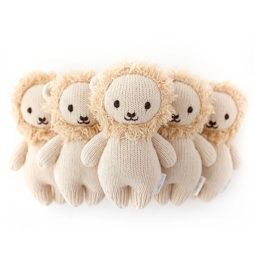 Soft baby lion plush toy from Cuddle + Kind featuring a cuddly lion with detailed facial features and plush fur.