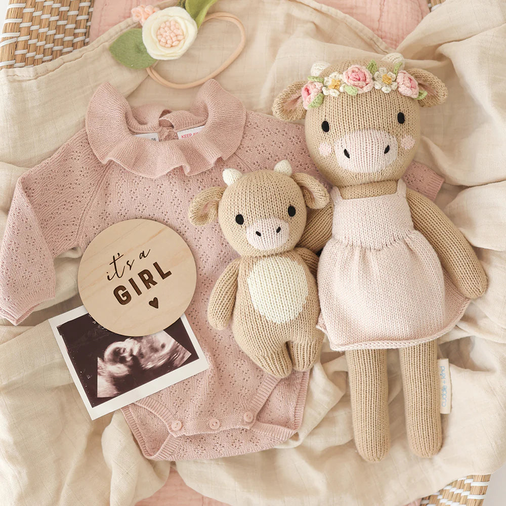 Amelia the Cow plush toy from Cuddle + Kind, soft and cuddly stuffed animal with detailed cow features and gentle expression.