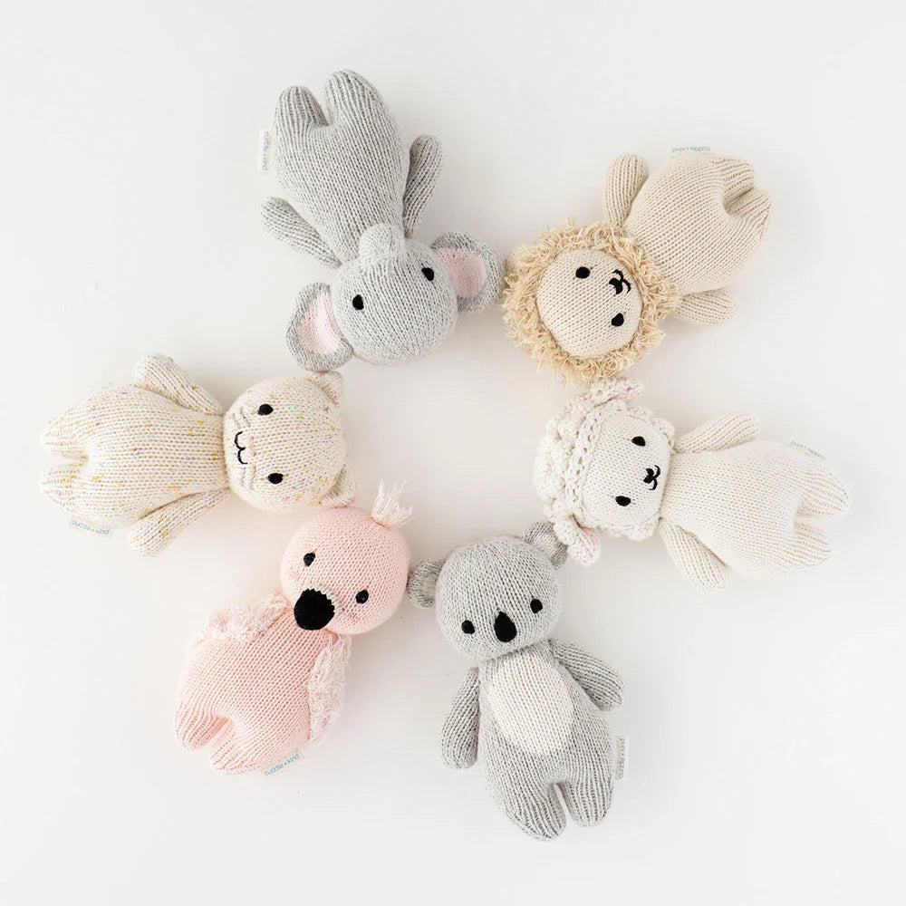 Soft plush baby elephant toy by Cuddle + Kind with gentle gray fur and large ears, perfect for cuddling and comforting infants.
