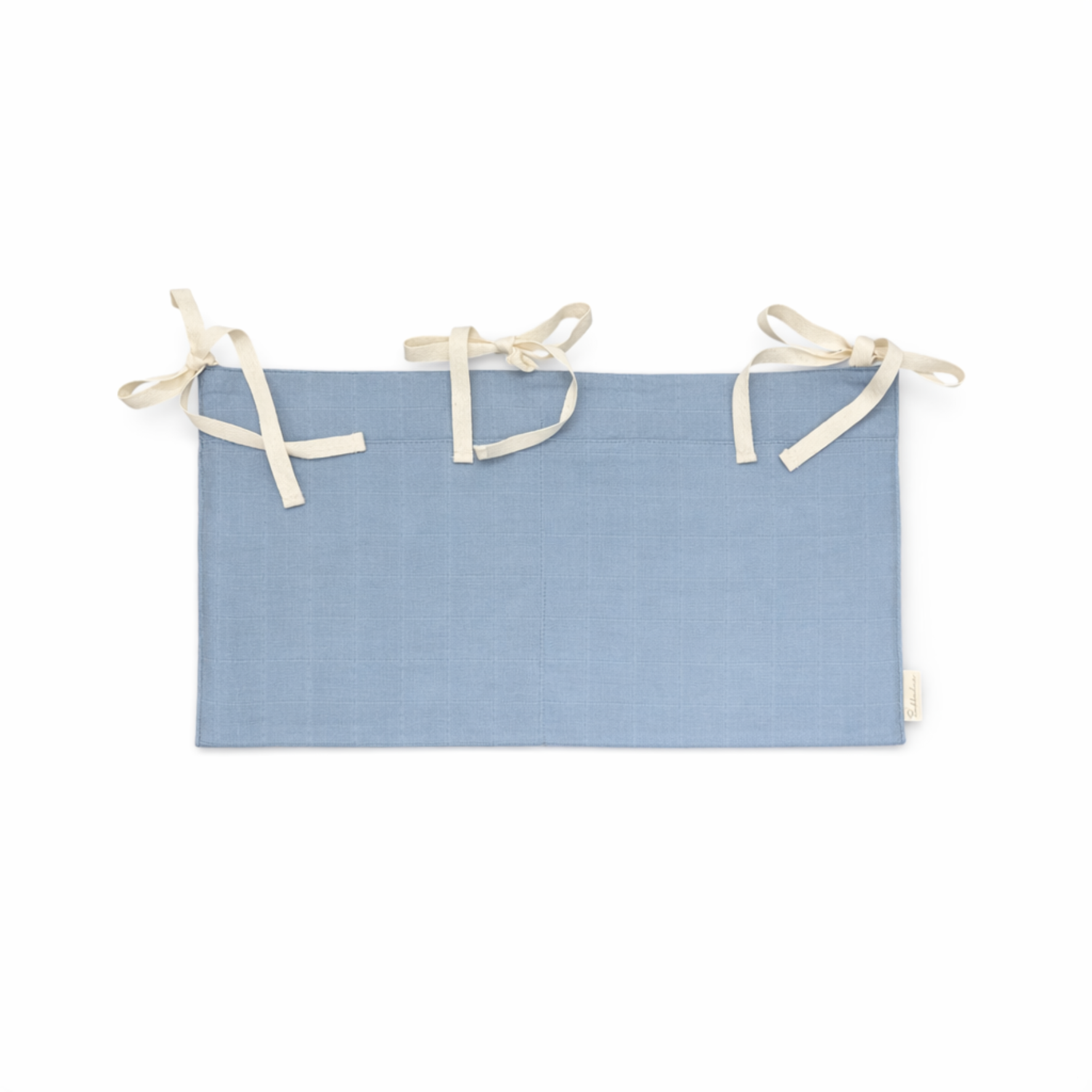 Bubbadue Muslin Cot Pocket in Misty Blue attached to a nursery cot, made of soft, breathable fabric for baby storage.