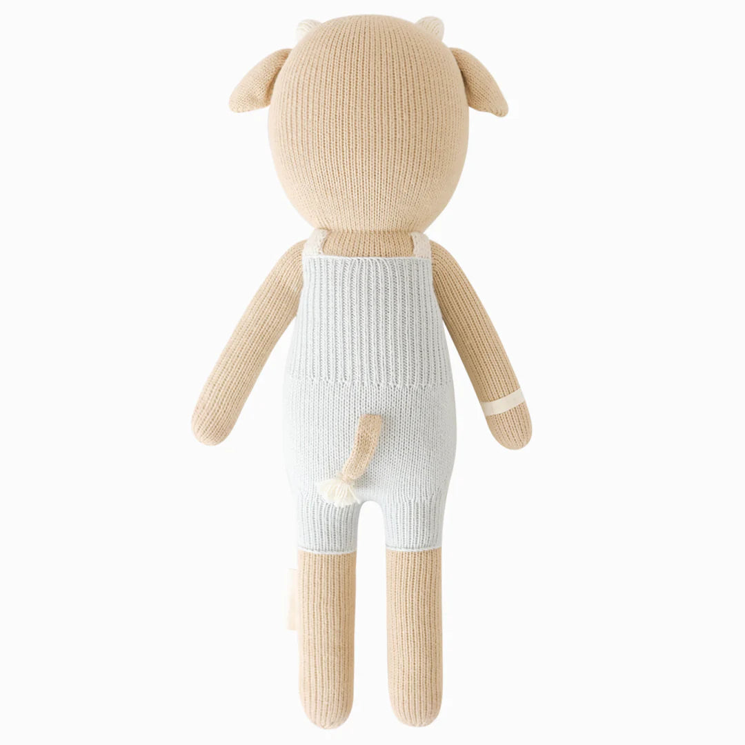 Back view of Asher the Cow plush toy by Cuddle + Kind, showing soft brown and white fur with detailed cow features.