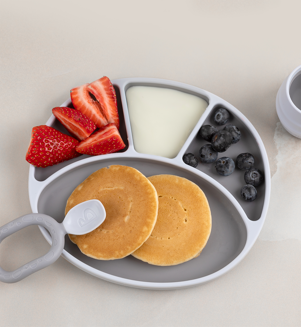 Bibado Silicone Suction Divider Plate in Mist color, featuring divided sections for children's meals, made of flexible silicone.