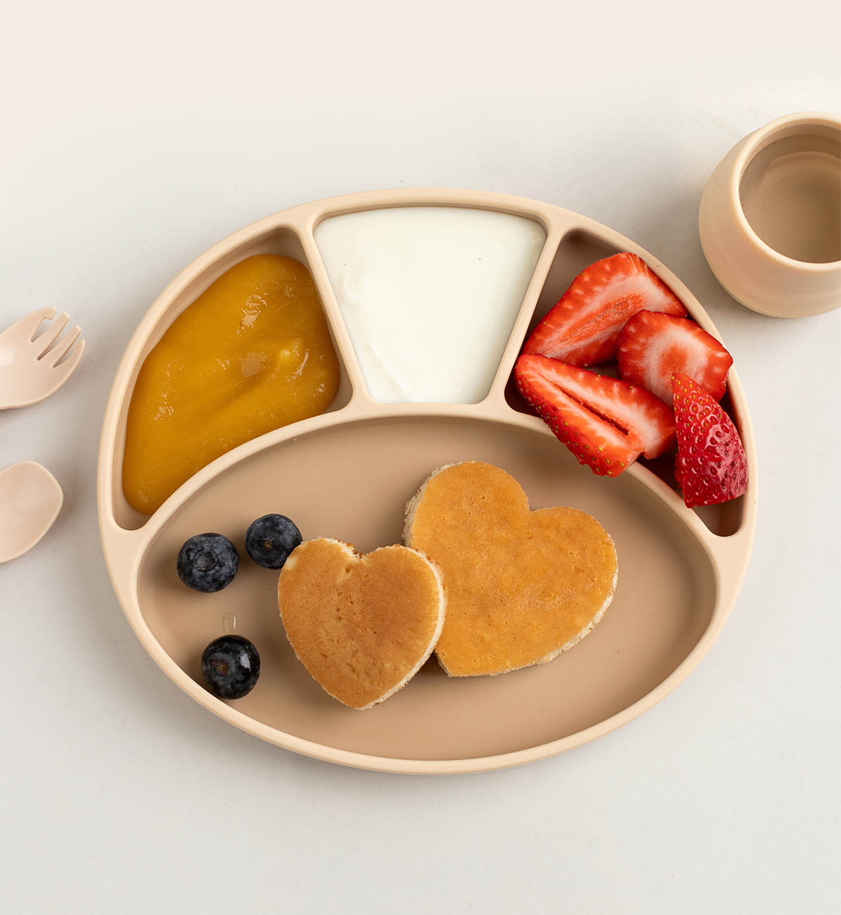 Bibado silicone suction divider plate in fawn color, designed for baby feeding, with multiple sections for easy mealtime organization.