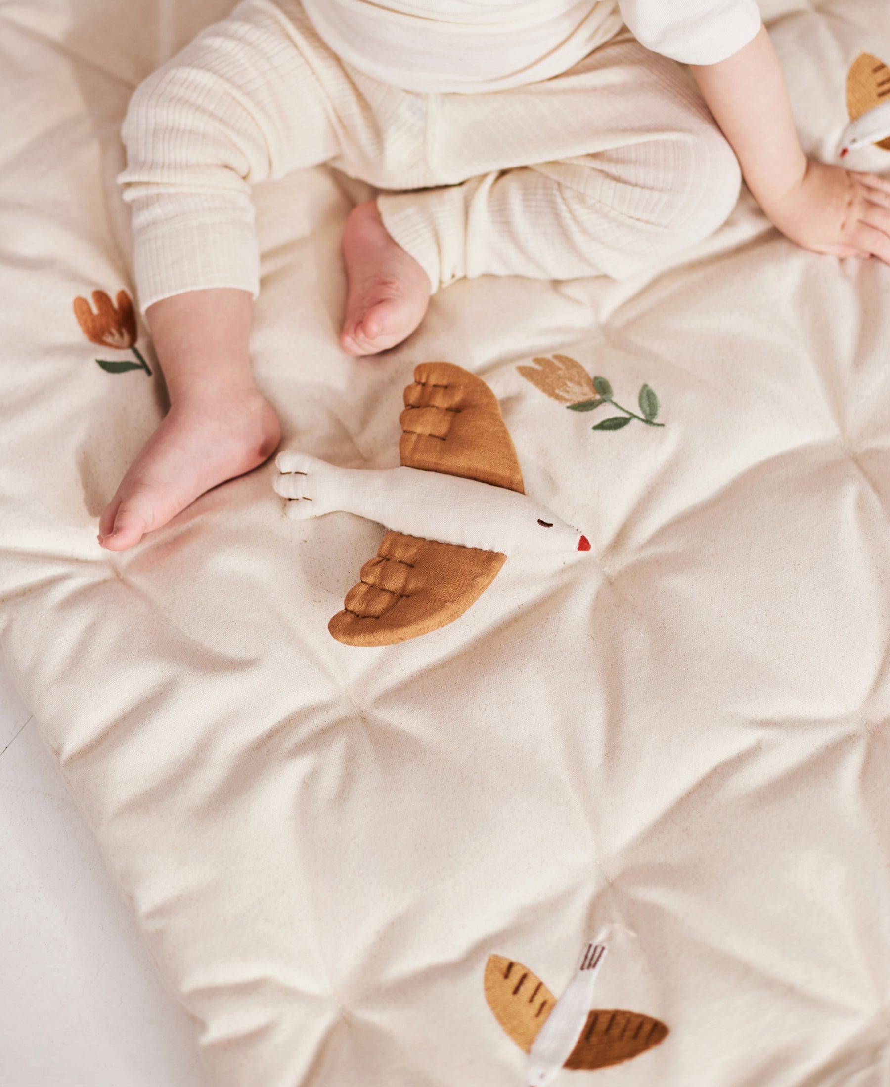 Dear April Meri Play Mattress in Songbirds pattern, featuring colorful bird and floral designs on a soft play mattress.