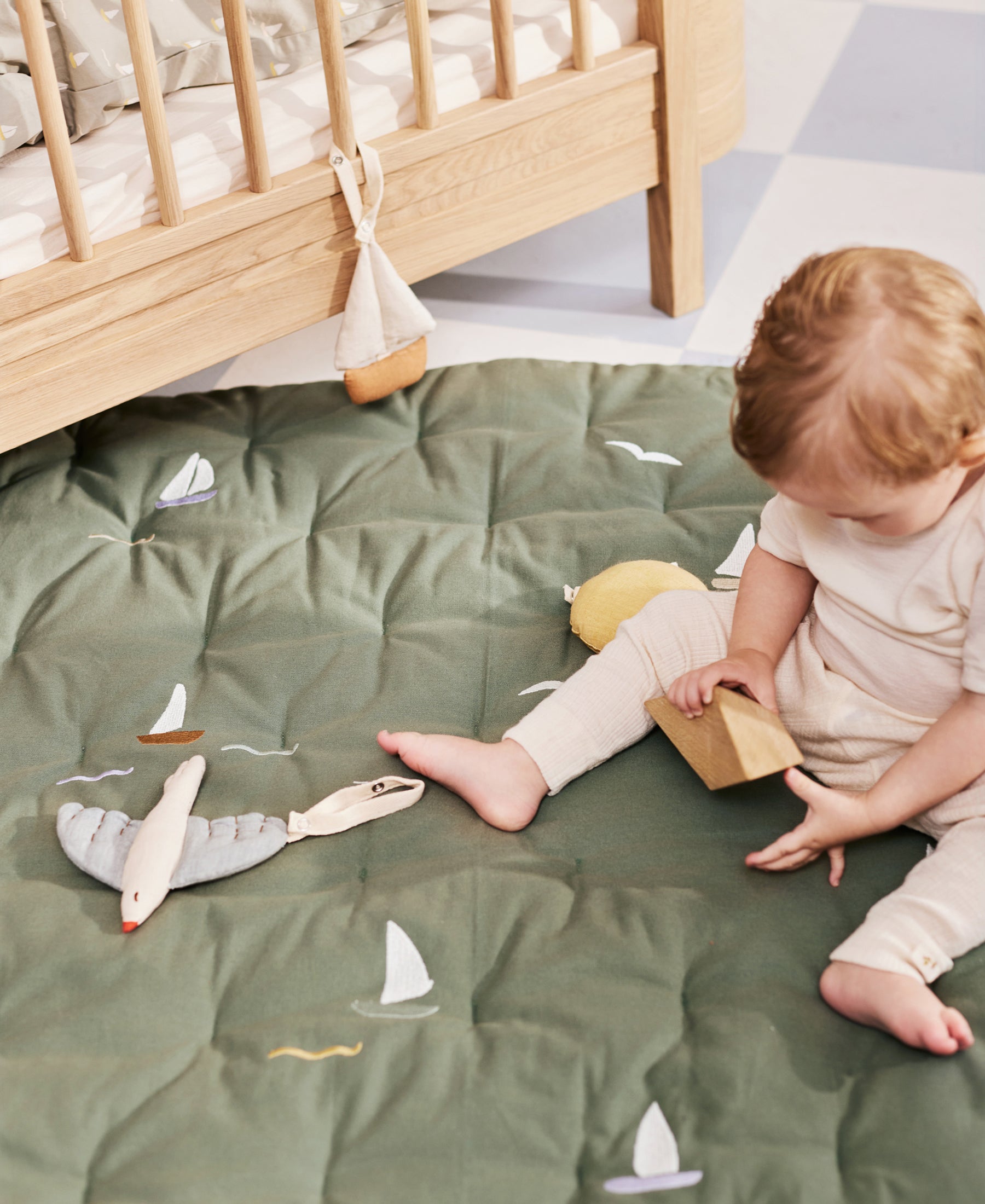 Dear April Meri Play Mattress with sailboat design, soft fabric surface perfect for toddler play and napping.