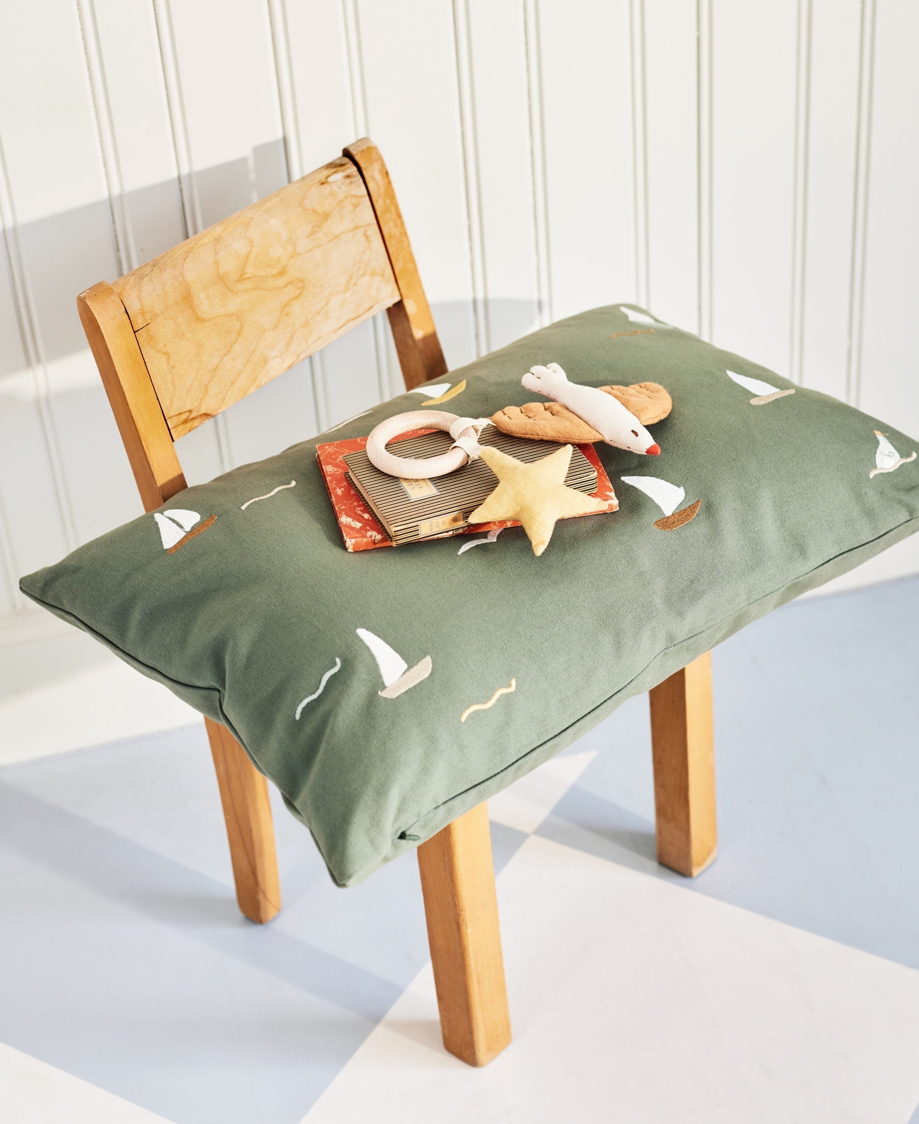 Dear April Cinna Cushion with sailboat print featuring colorful sailboats on a soft fabric cushion for coastal decor.
